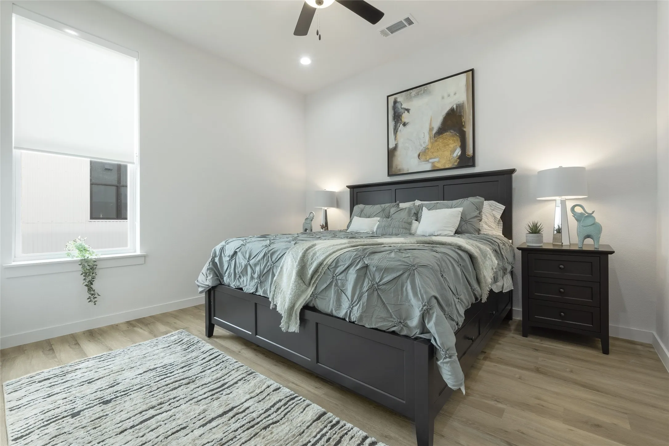 Light wood-finish flooring with white walls