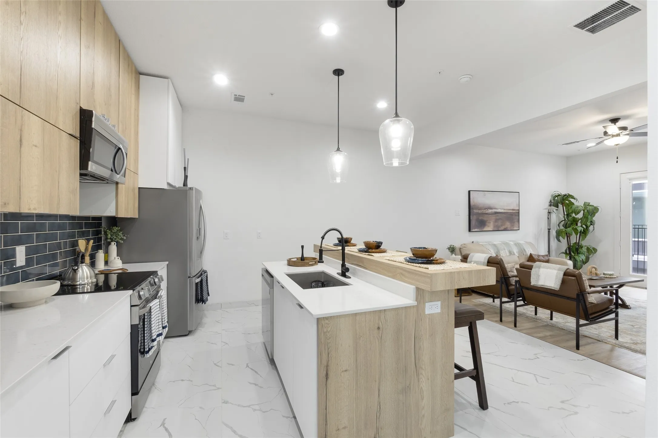 Kitchen island with a built-in sink and breakfast bar