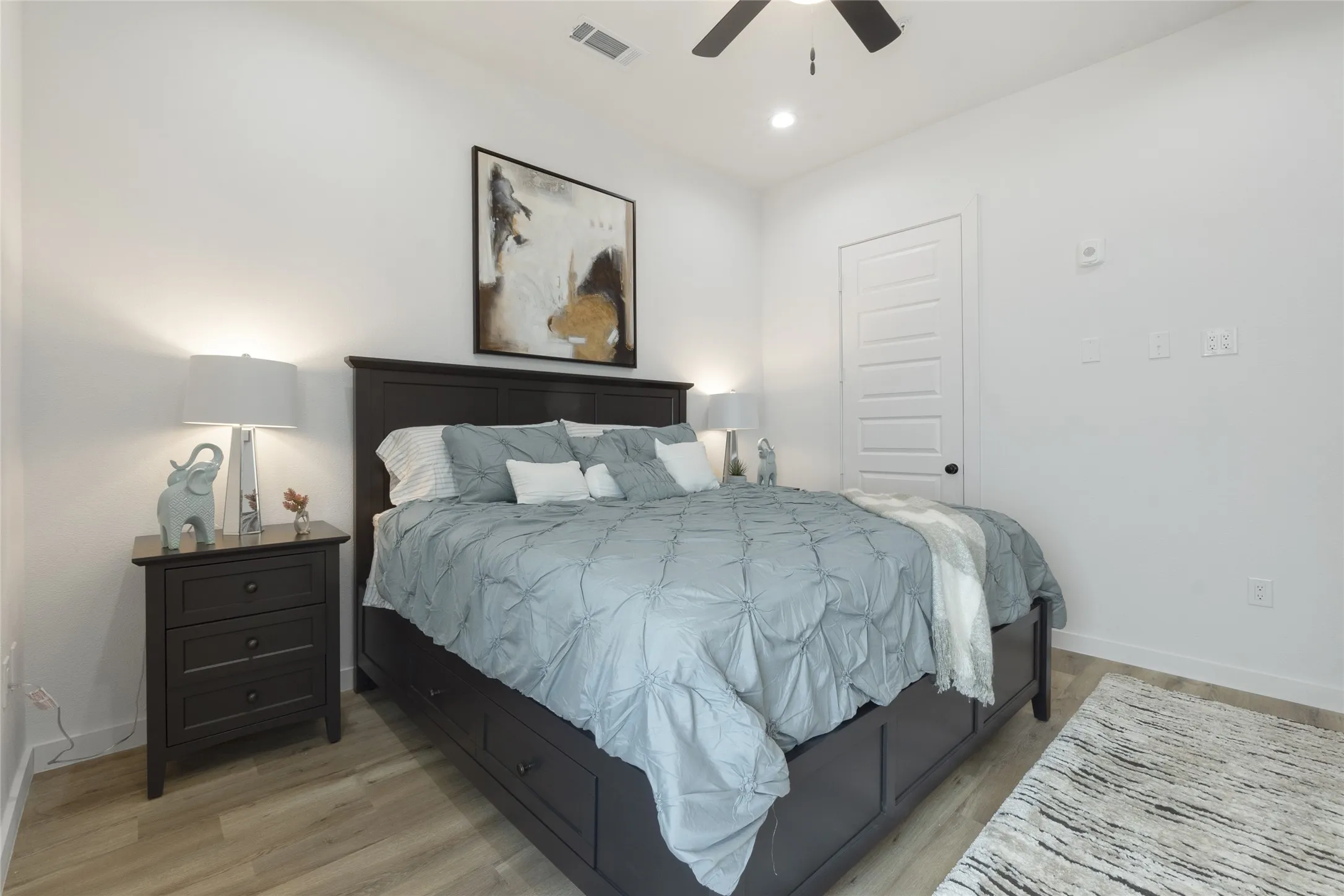 Recessed lighting, wood-finish flooring, ceiling fan, and paneled interior door