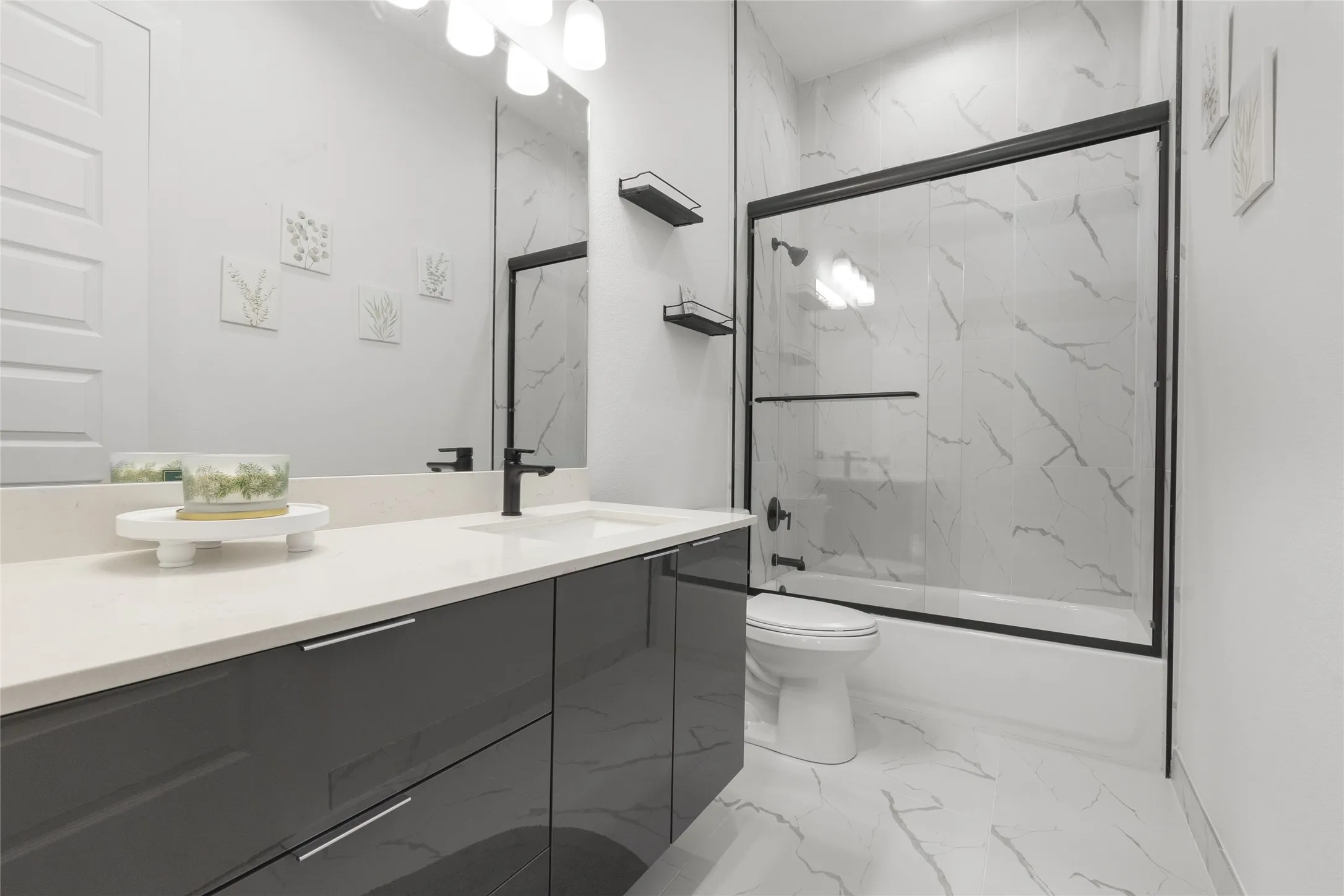 Glossy gray vanity with an integrated sink and light-toned countertop