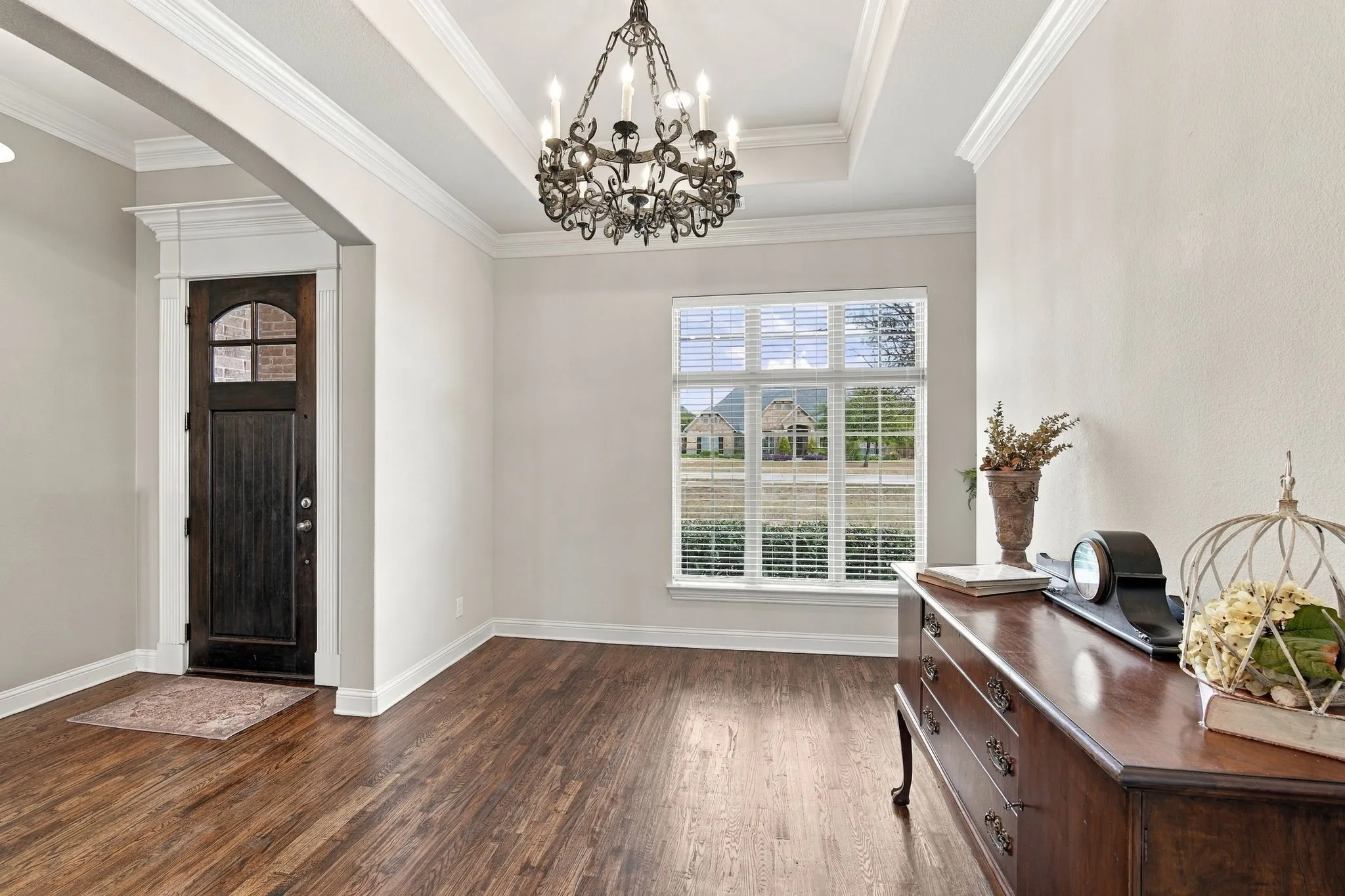 Nice, sunny office with shelving and hardwood floors