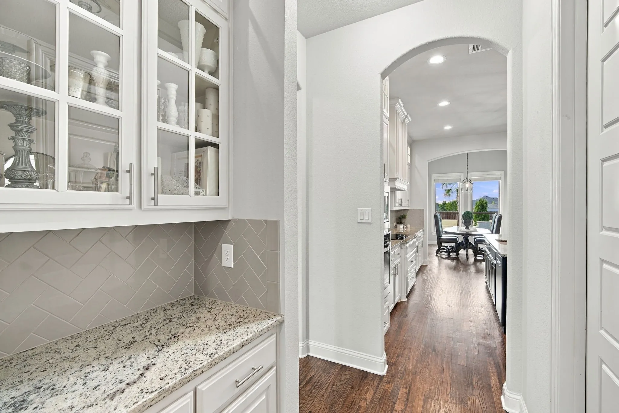 Coffee Bar with upper cabinet lighting, storage, and granite countertops