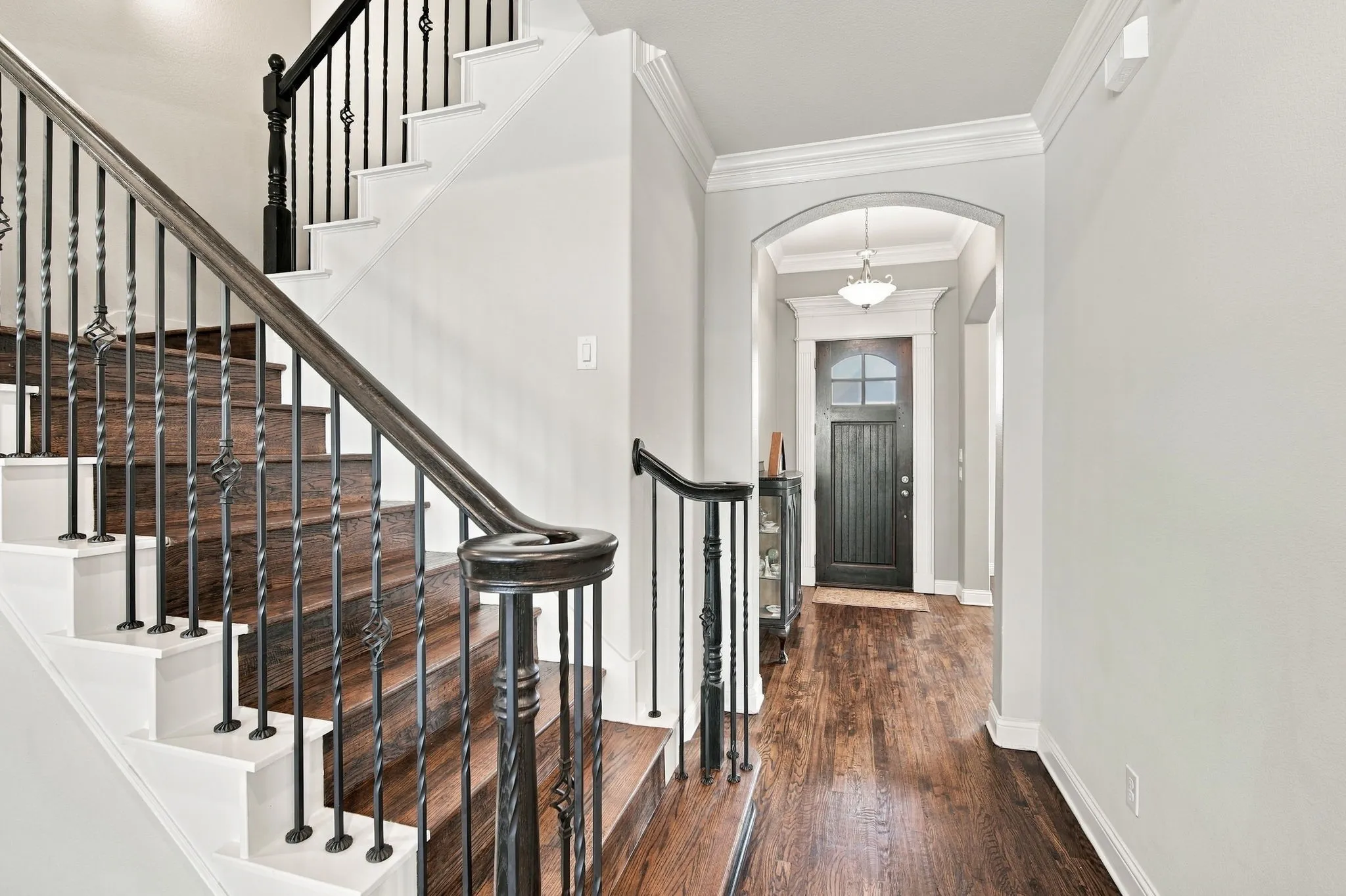 Gorgeous hardwood floors and ambient lighting create an inviting entrance
