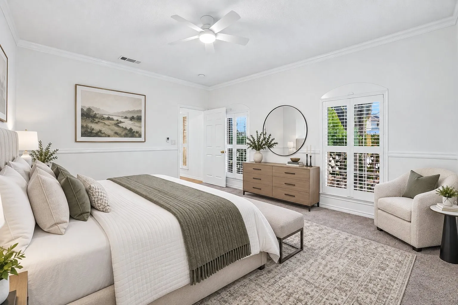 White walls with a chair rail, crown molding, and a ceiling fan with integrated lighting