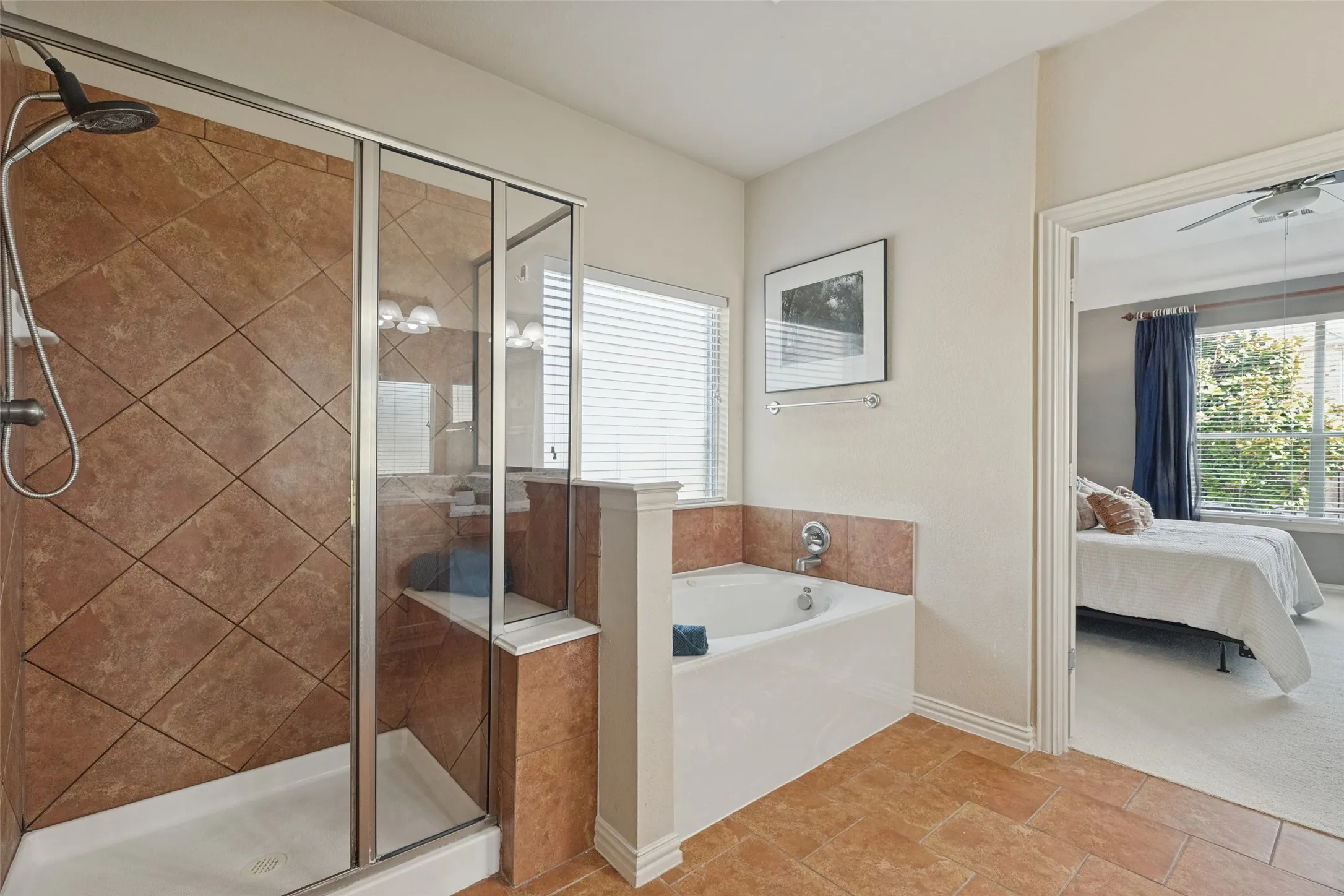 “Private primary bath features a separate soaking tub and tiled walk-in shower, creating a relaxing ensuite retreat just steps from the primary bedroom.