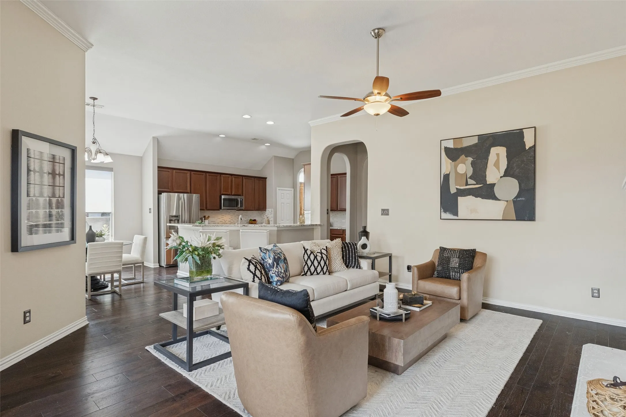 Open-concept living area offers a spacious, inviting layout with rich hardwood floors, high ceilings, and seamless flow into the kitchen and breakfast area—perfect for everyday living and entertaining.