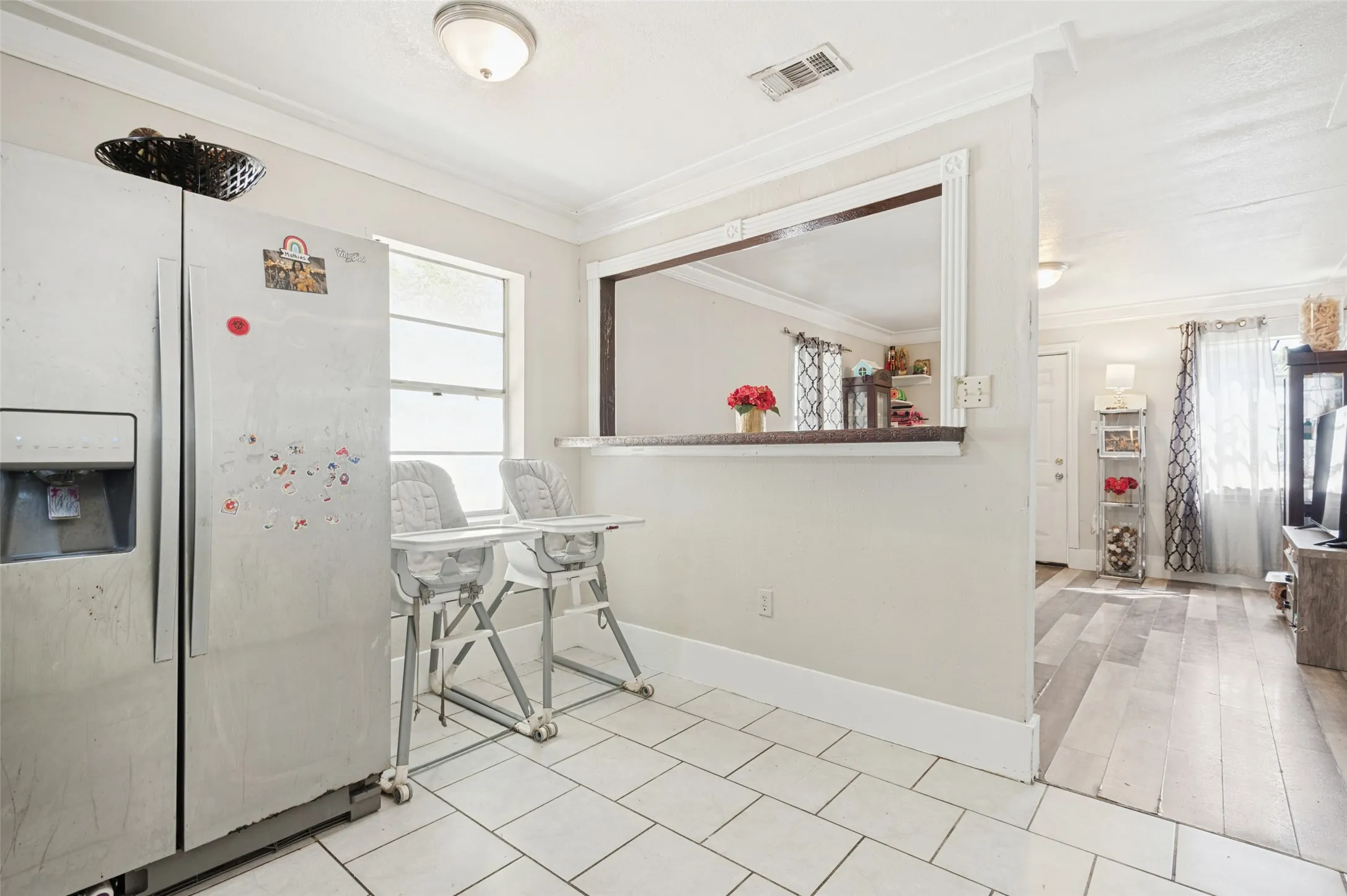 Tile flooring, pass-through window, wood-finish flooring, crown molding, double-pane window
