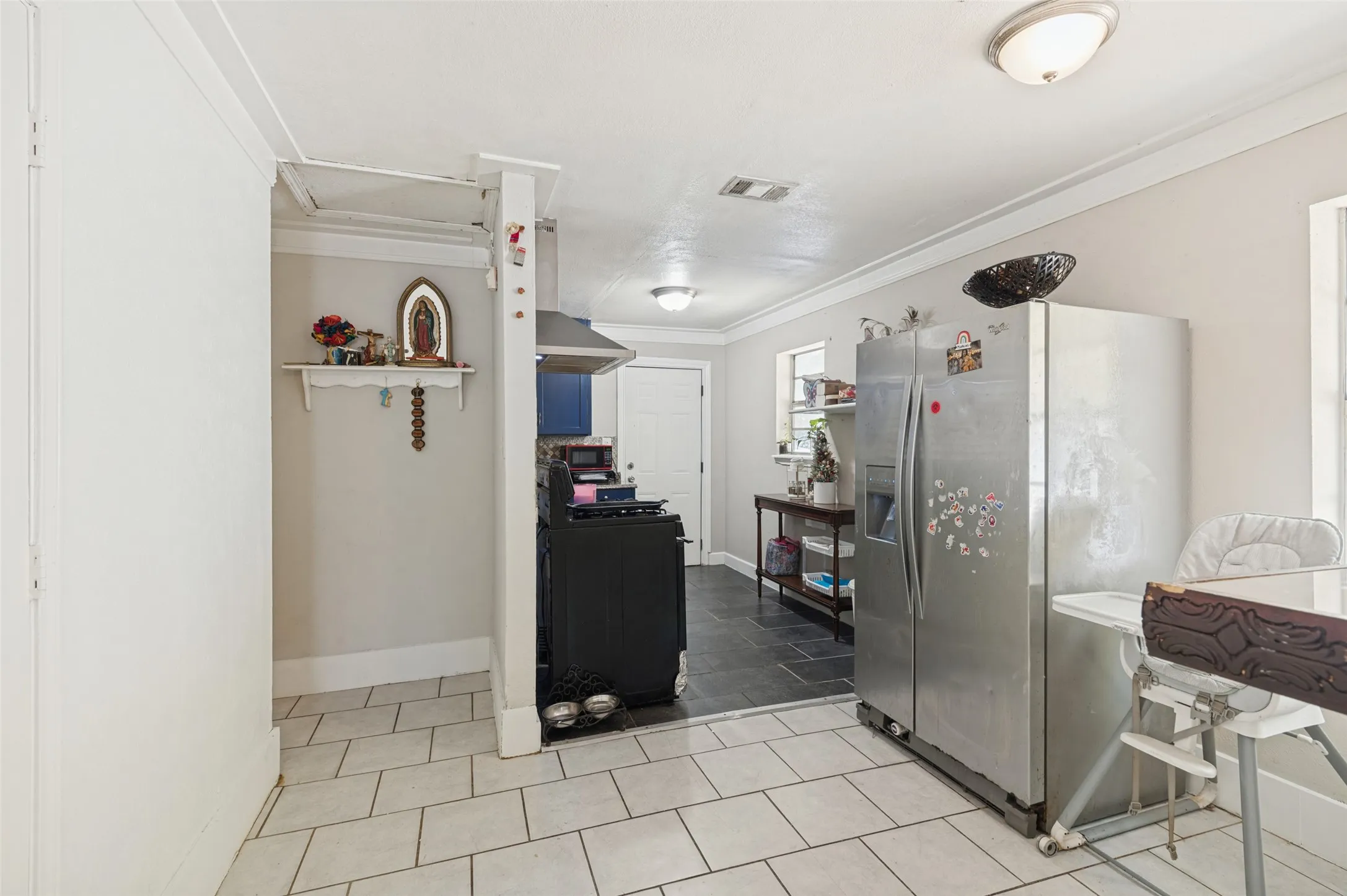 Kitchen area featuring tile flooring, recessed lighting, and built-in cabinetry