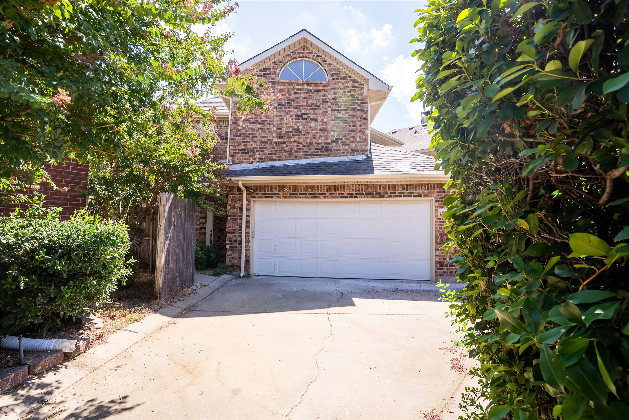Brick exterior with a prominent arched window on the upper level