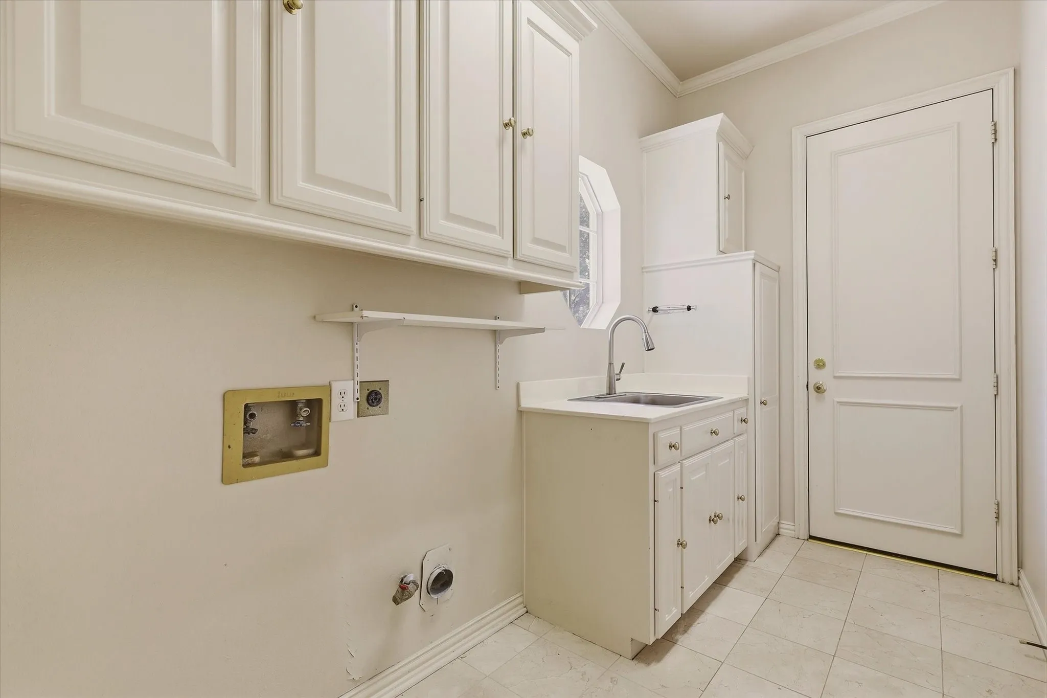 The Utility Room is nicely sized and offers storage and a sink.