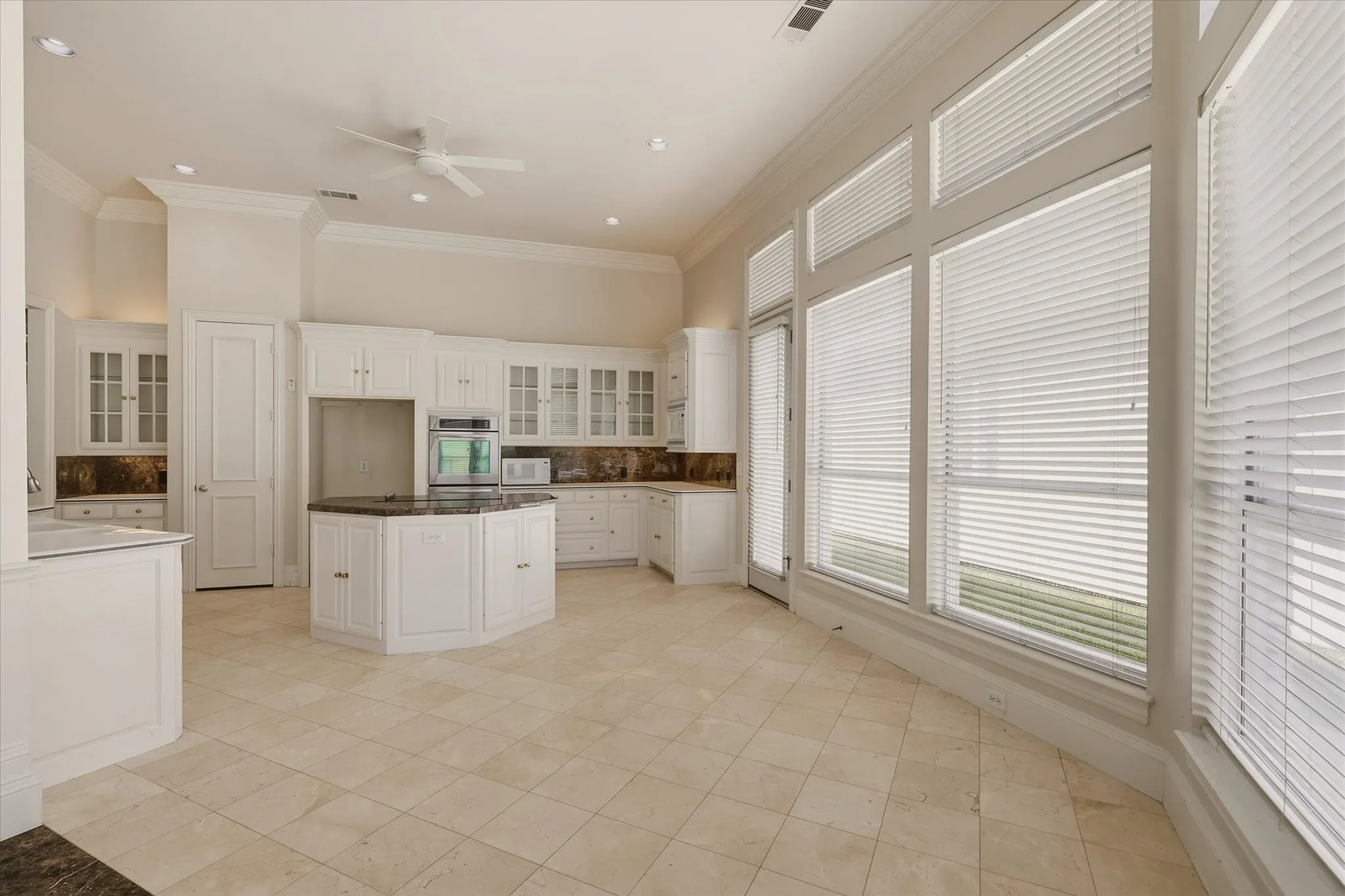 The Kitchen has marble countertops, an island and lots of cabinets