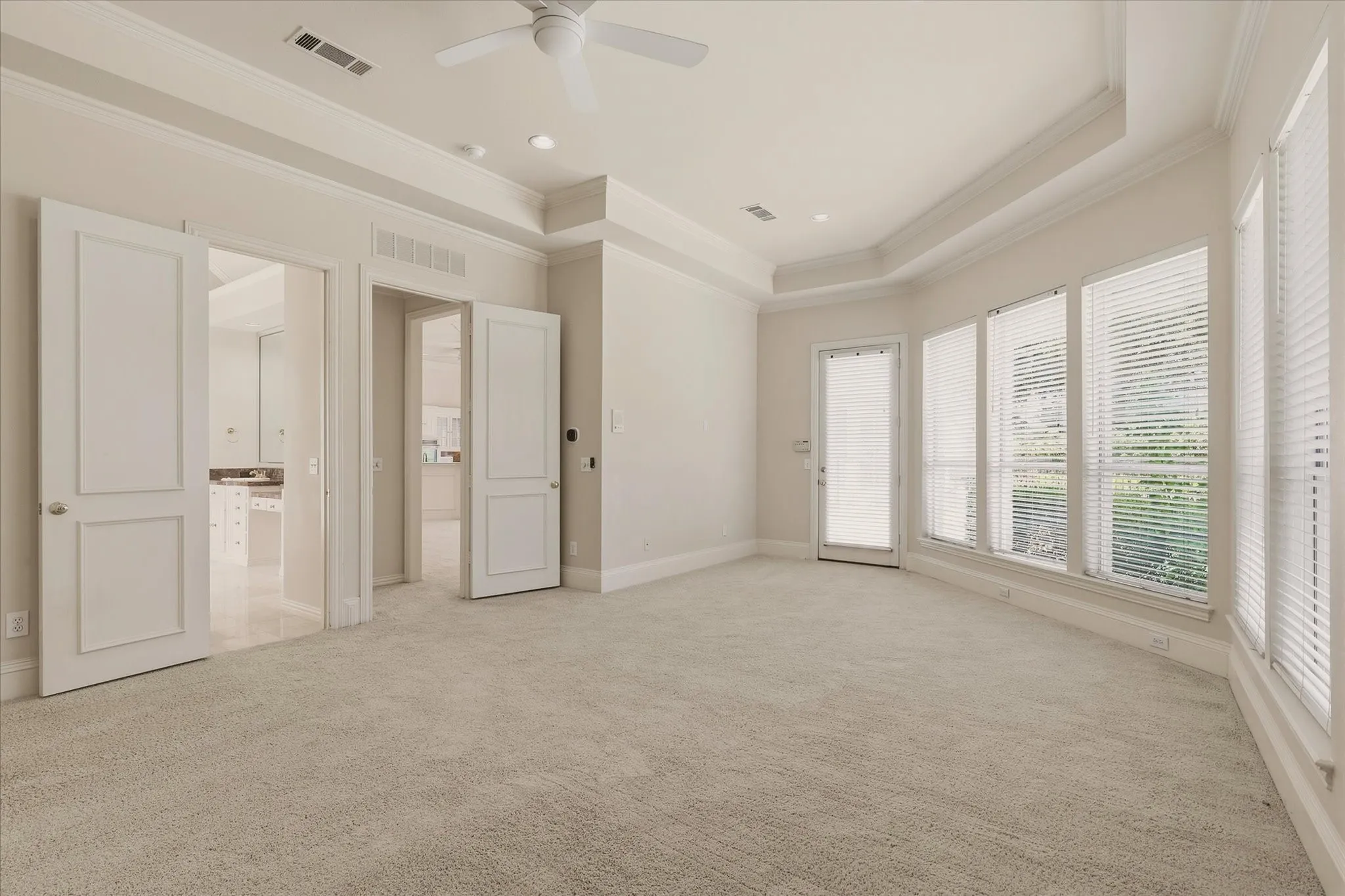 View of Sitting area in the Primary Bedroom with door to the back yard pool and spa.