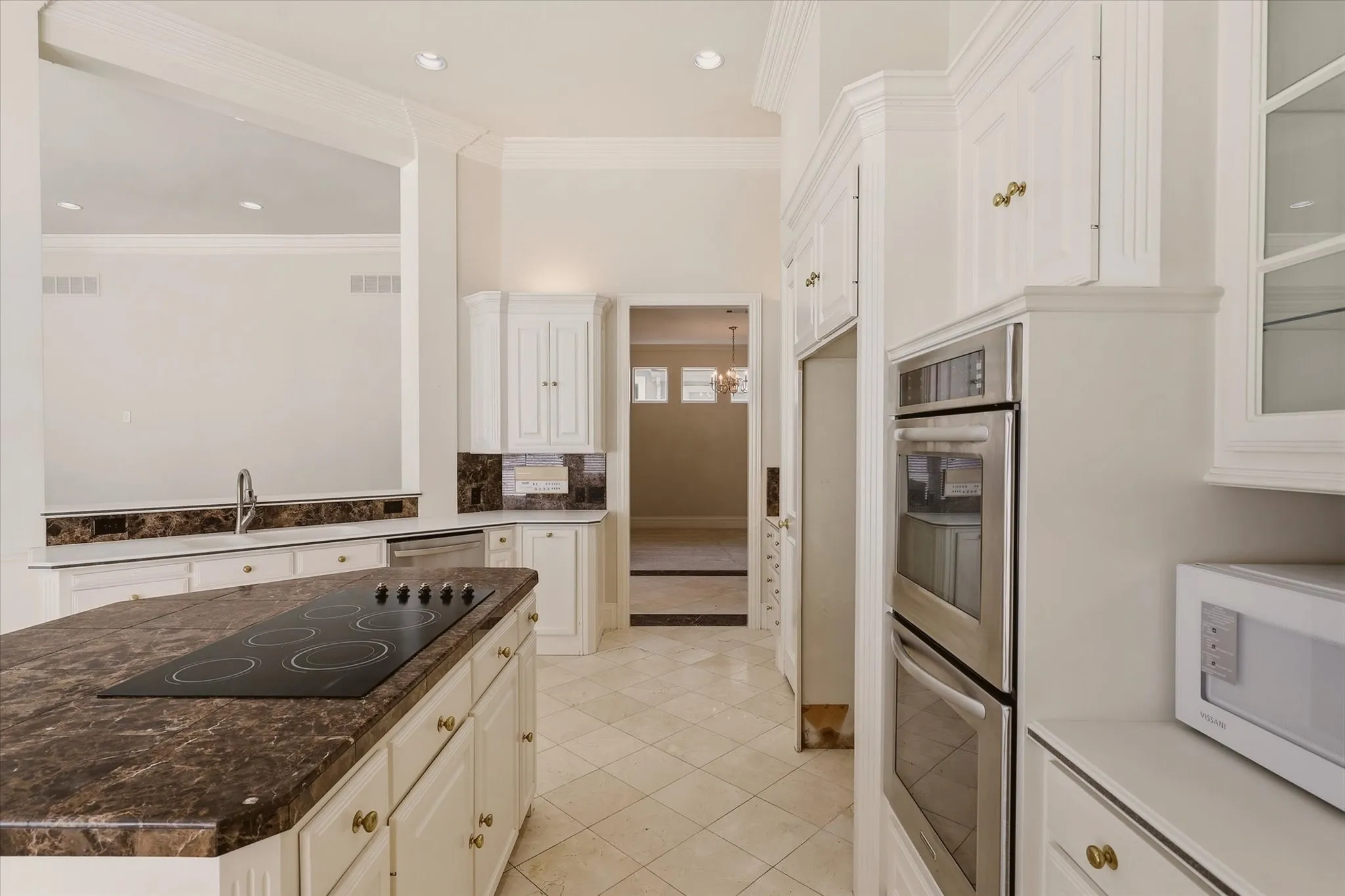 The Kitchen includes an electric cooktop on the island and double ovens.