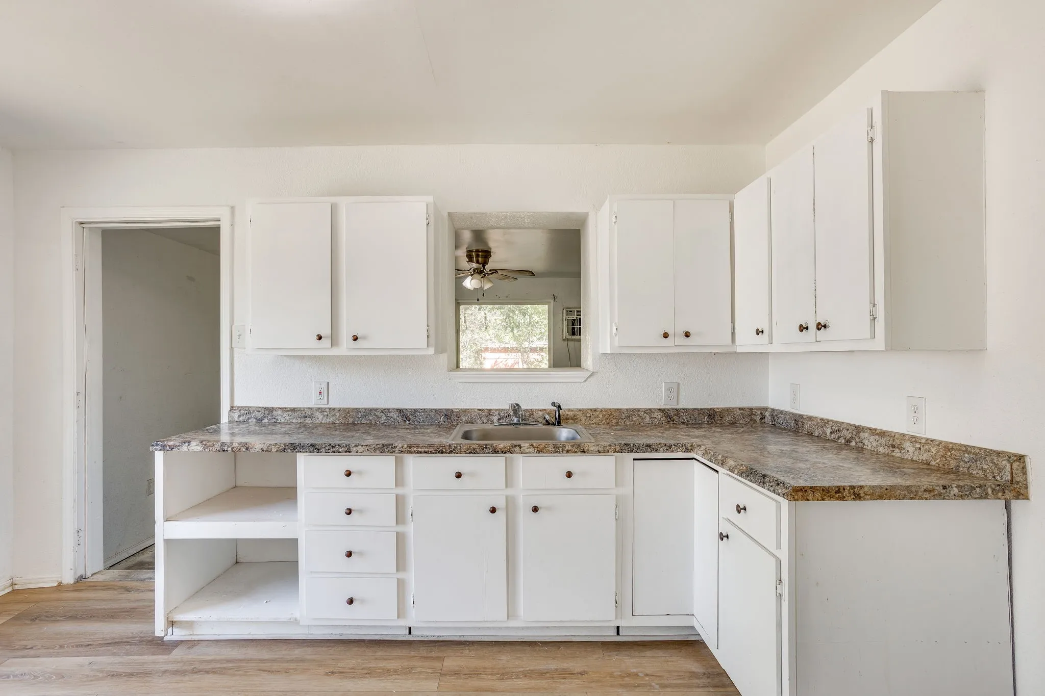 Kitchen open to the enclosed back porch for utility.
