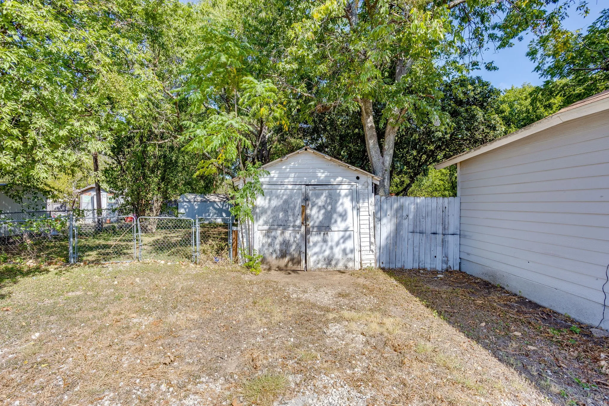 Single car garage with manual open doors.