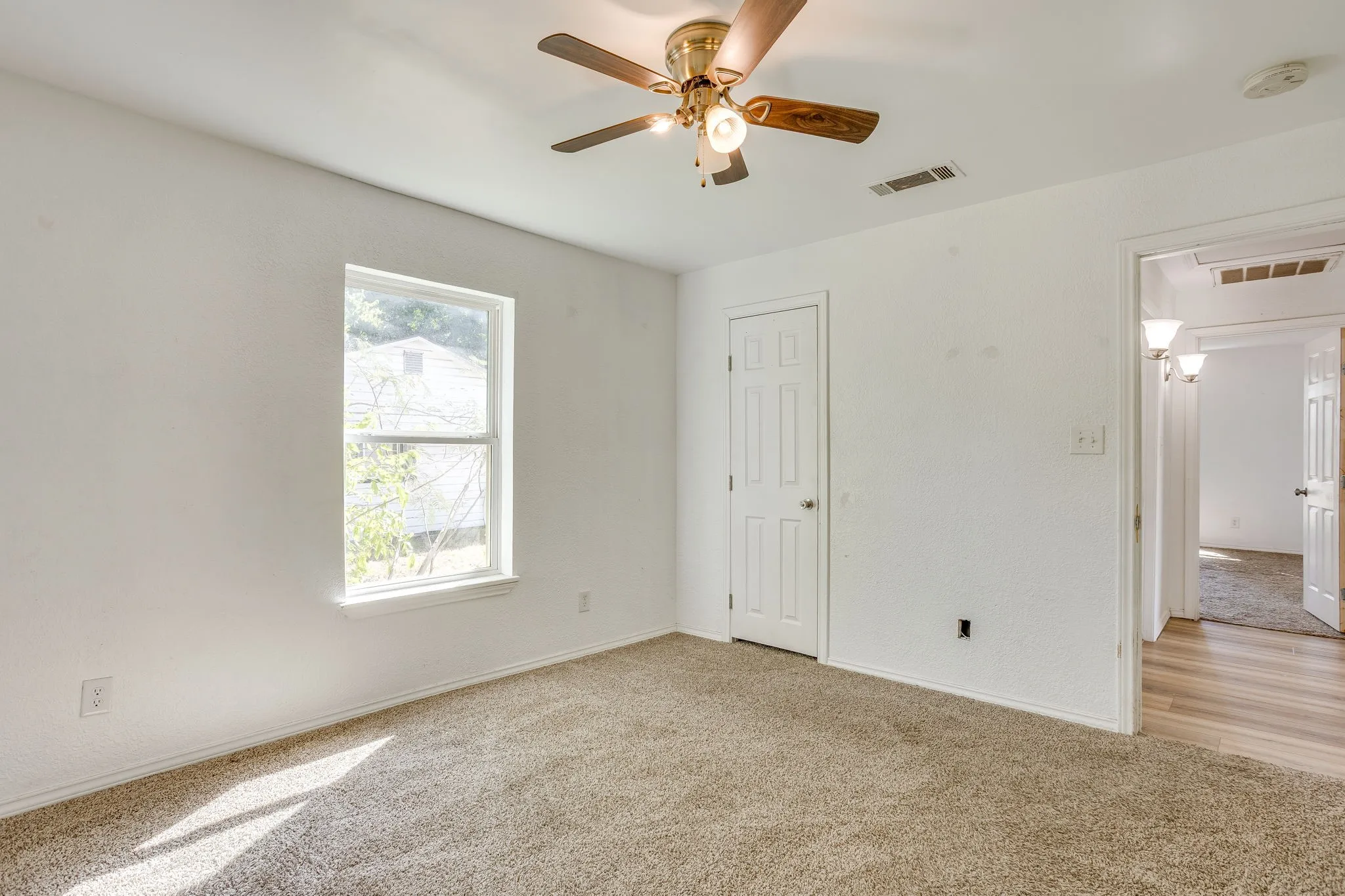 Bedroom with great natural light, carpet 2024 and ceiling fan.
