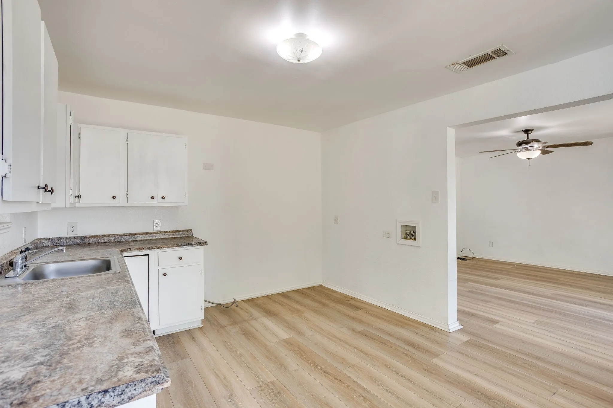 Kitchen with laminate flooring open with great flow to the living room.