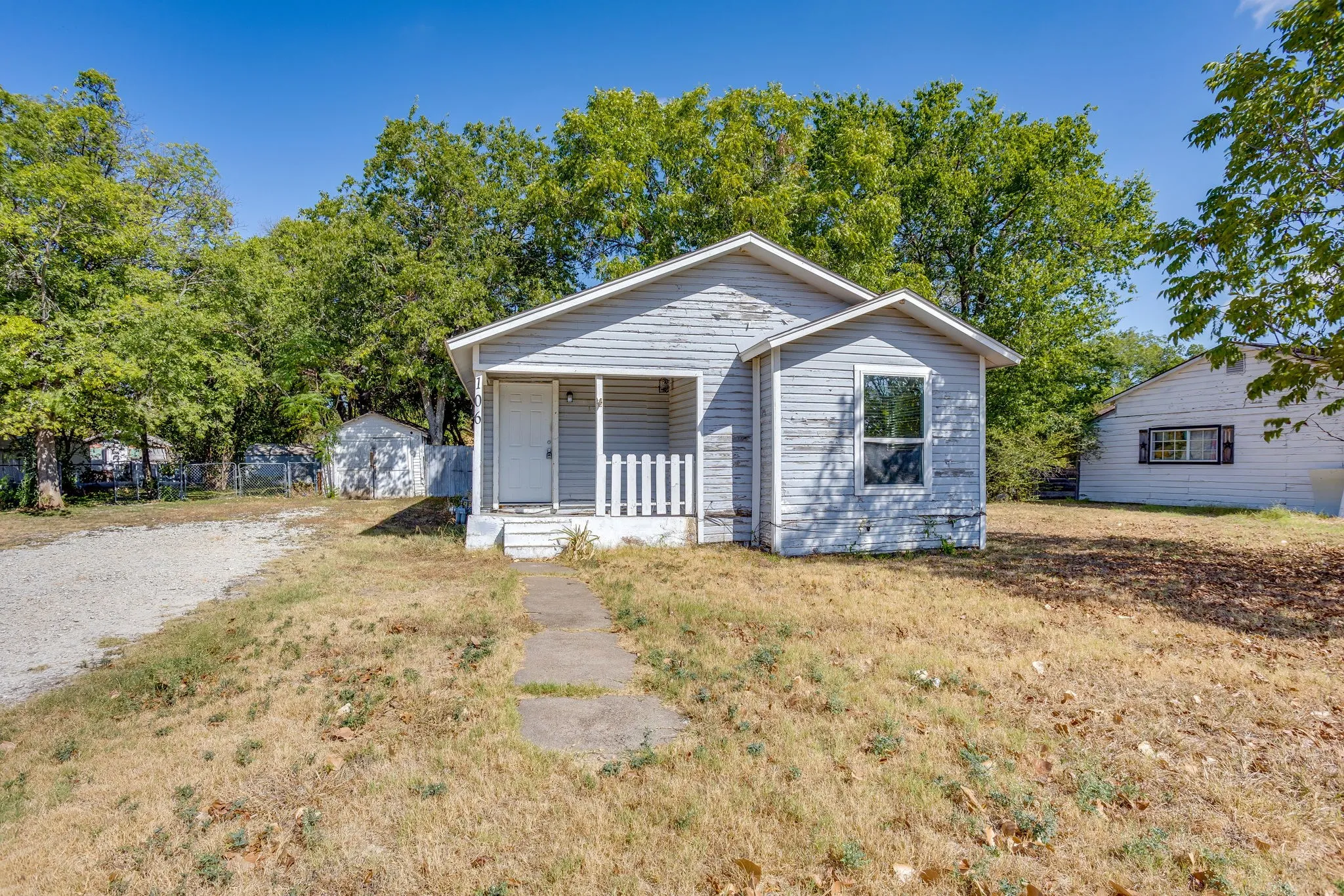 Traditional home with wood siding and sweet front porch and large two lots sold together!