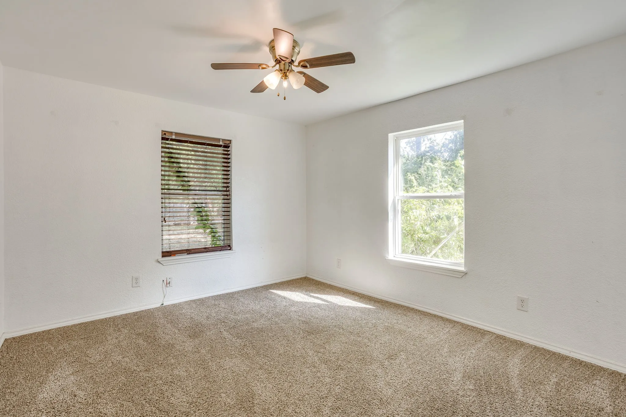 Primary bedroom with great natural light, ceiling fan and walk in closet.