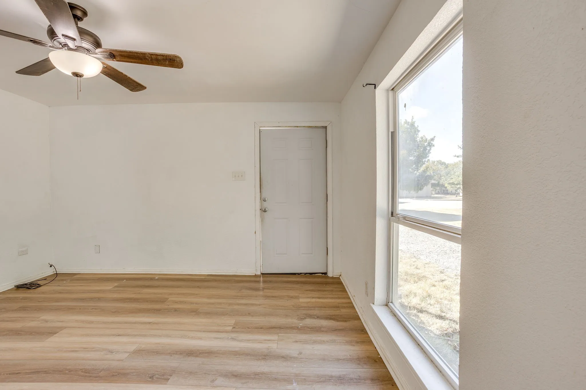 Front living space with laminate flooring and fresh paint 2024.