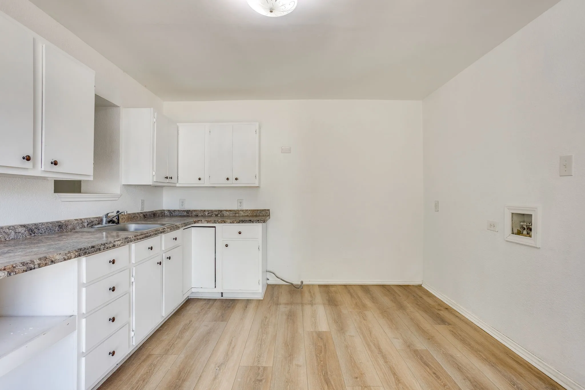 Kitchen with plenty of room for a large fridge and stove.