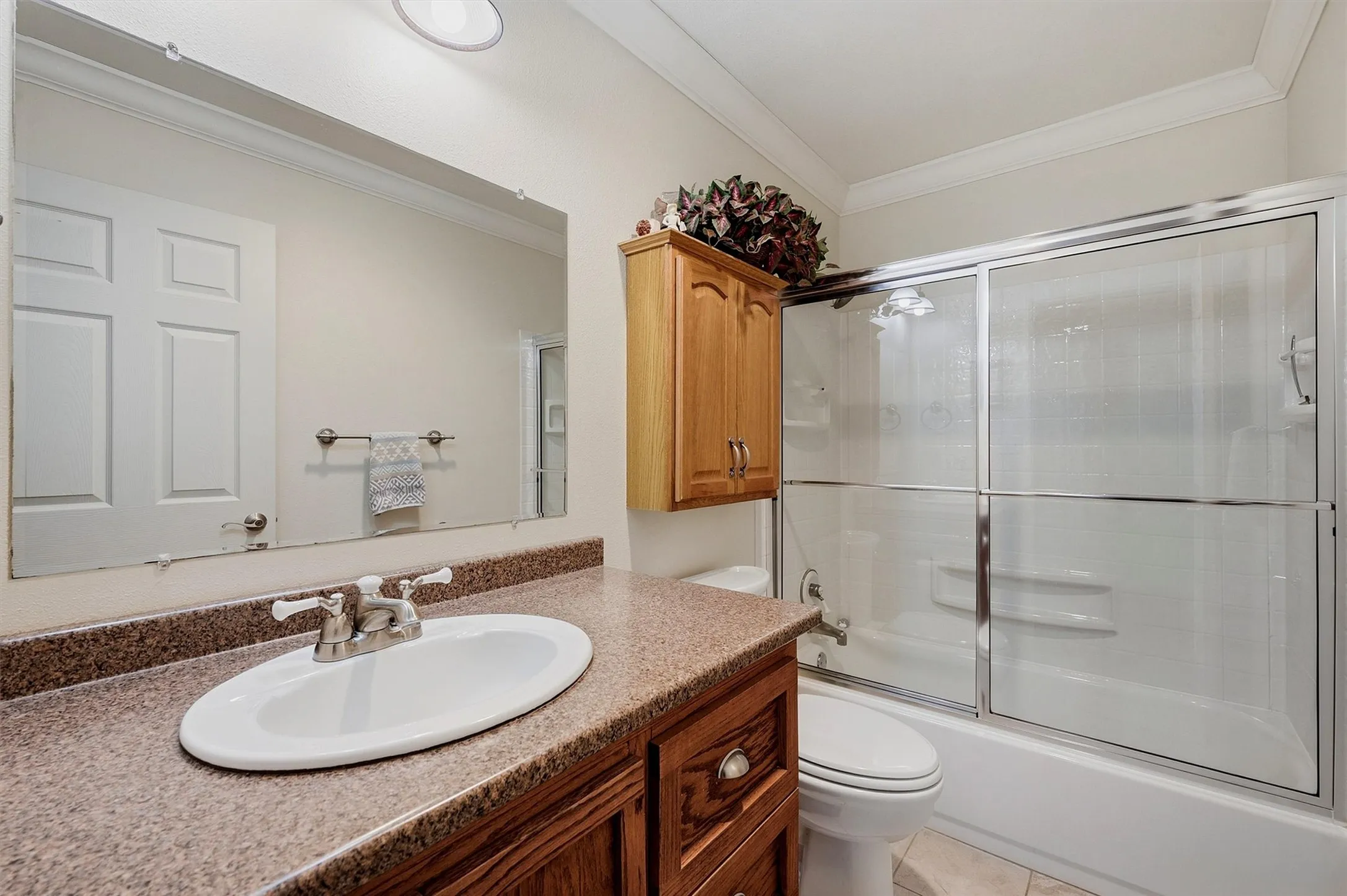 Built-in vanity with a composite countertop and white oval basin