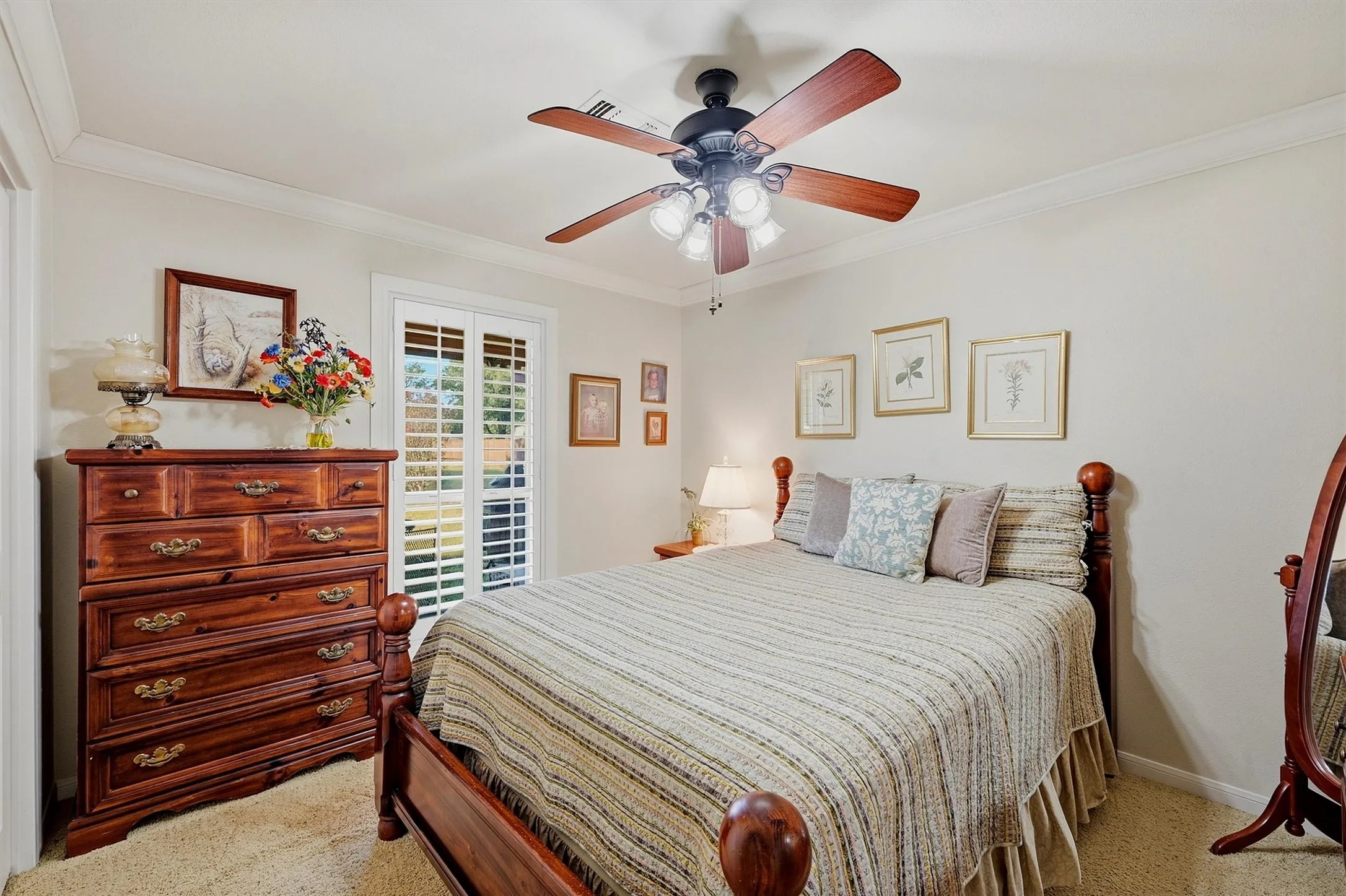 Neutral wall tones, crown molding, and a ceiling fan with integrated lighting