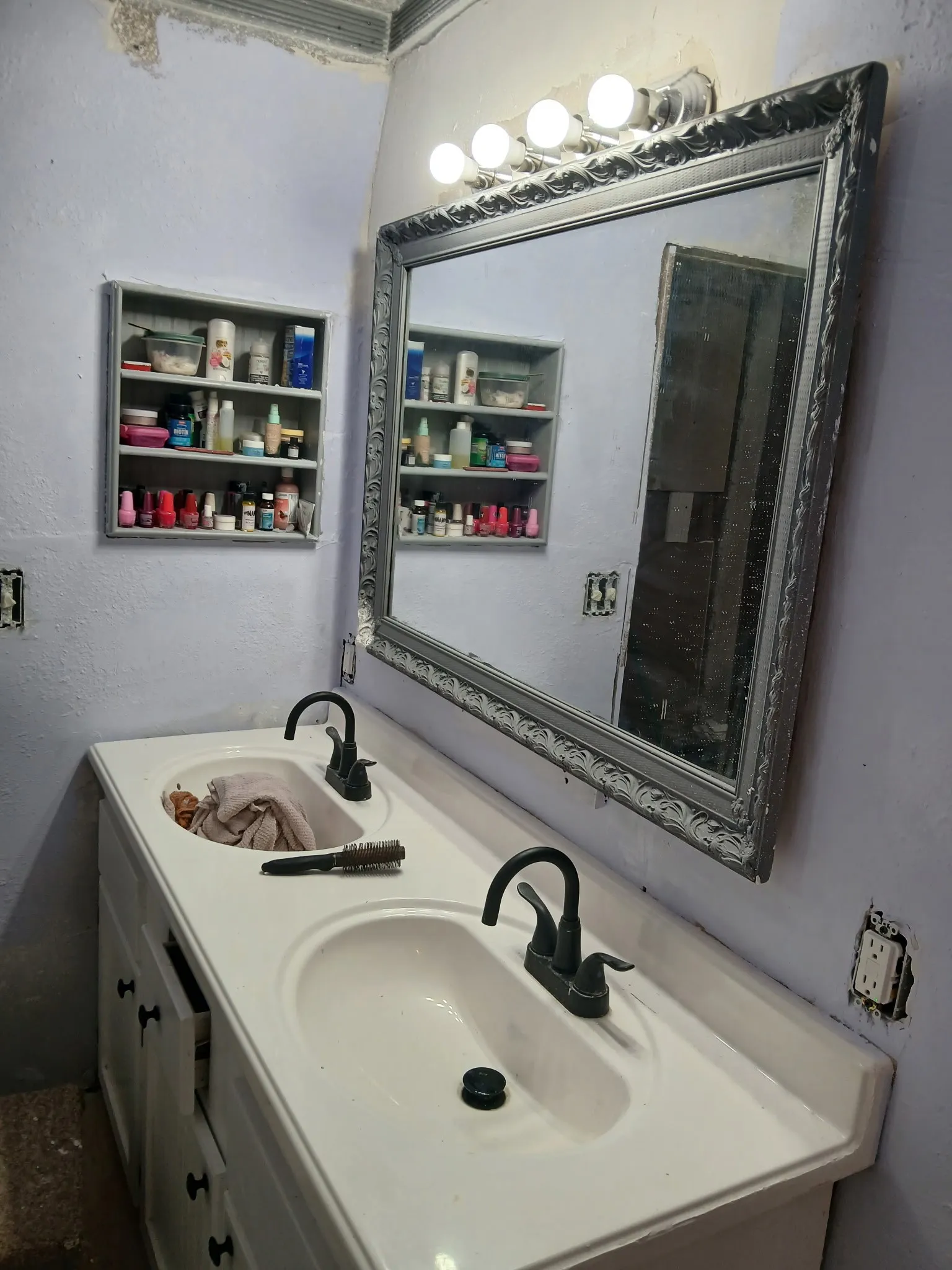 Dual basin vanity with white countertop and dark-finished fixtures