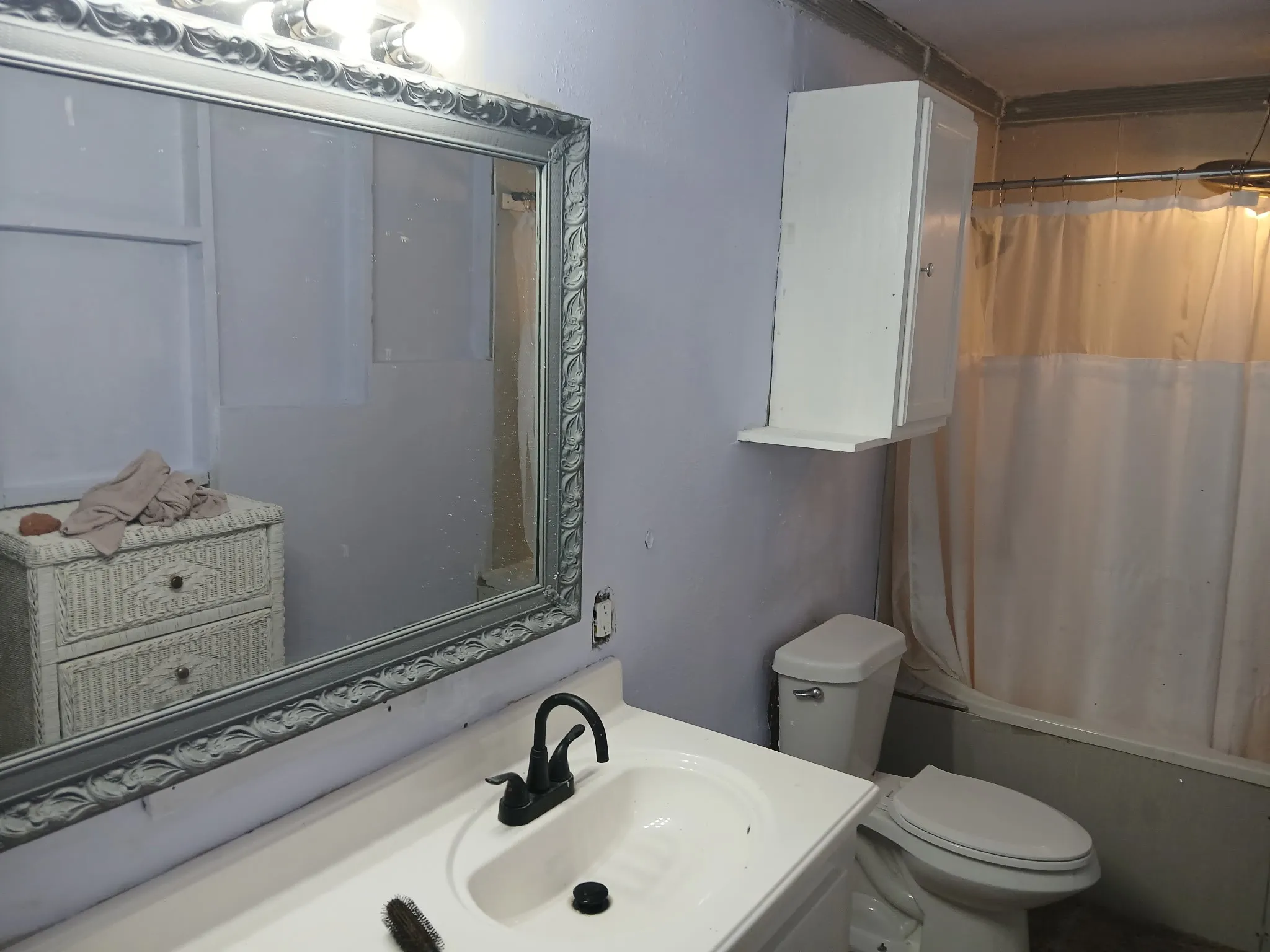 Vanity with an integrated sink and dark-finished faucet