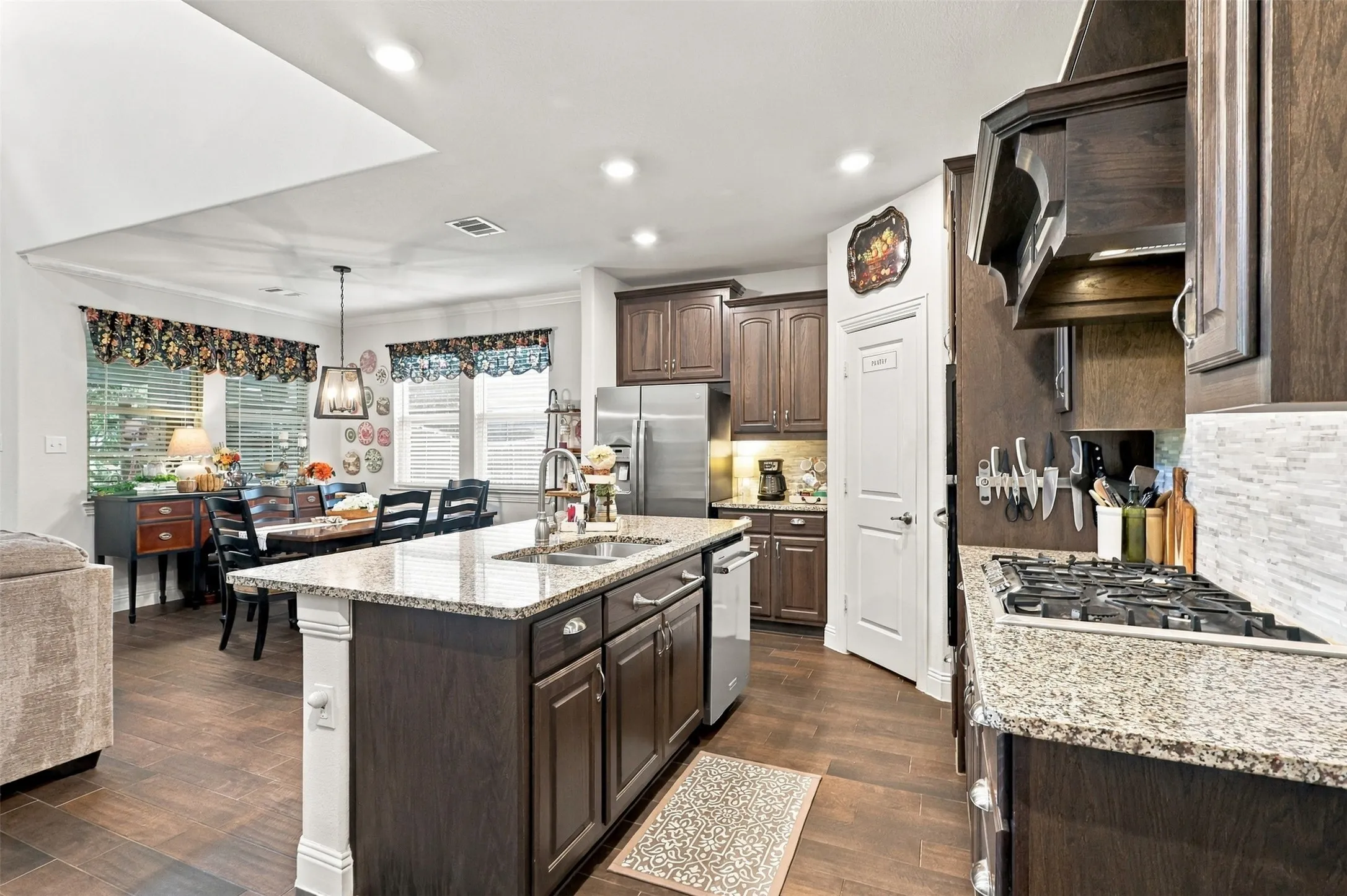 Gas stove, granite countertops and a walk in pantry open to the living and dining area