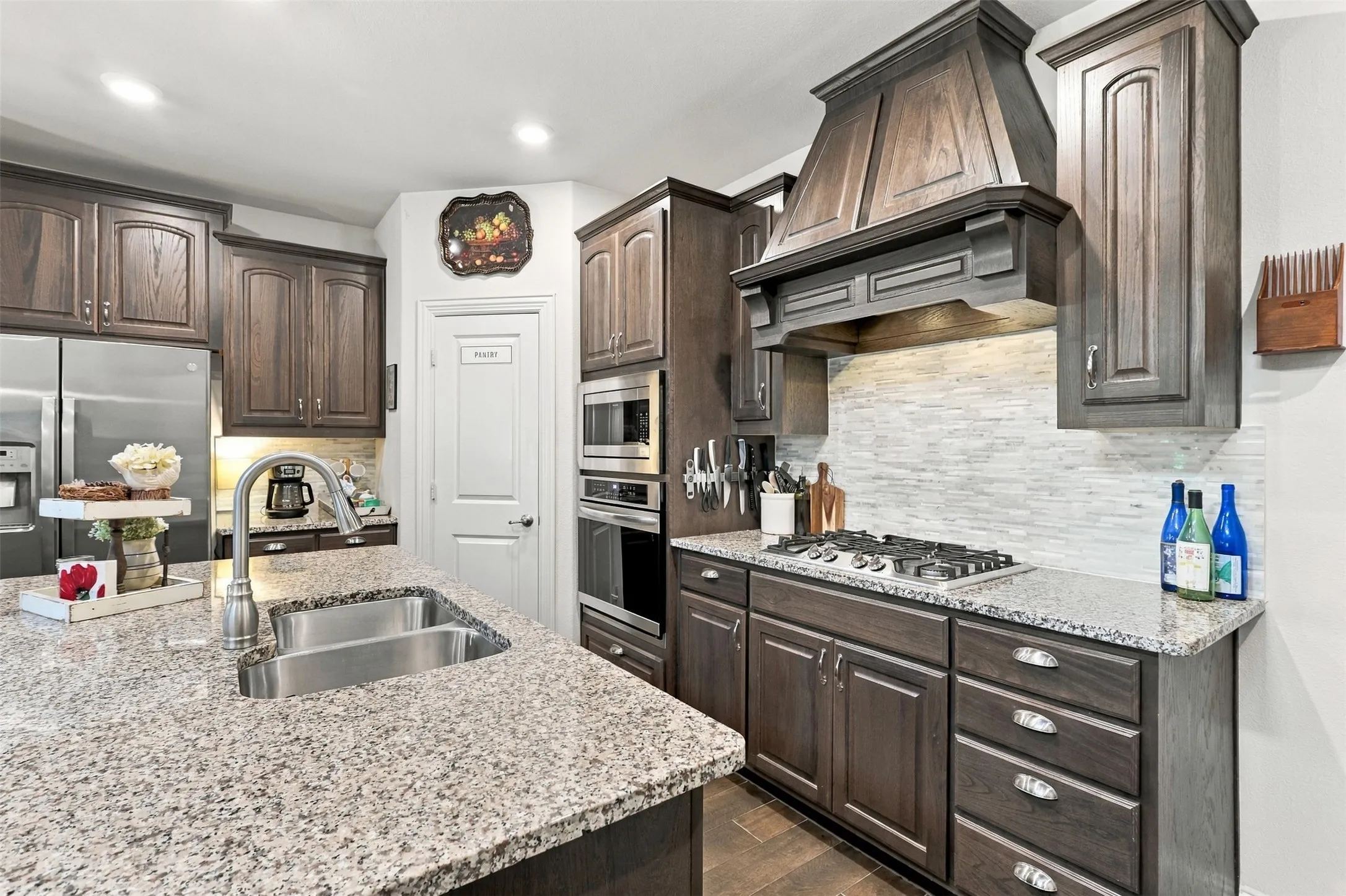 Gas stove, granite countertops and a walk in pantry open to the living and dining area