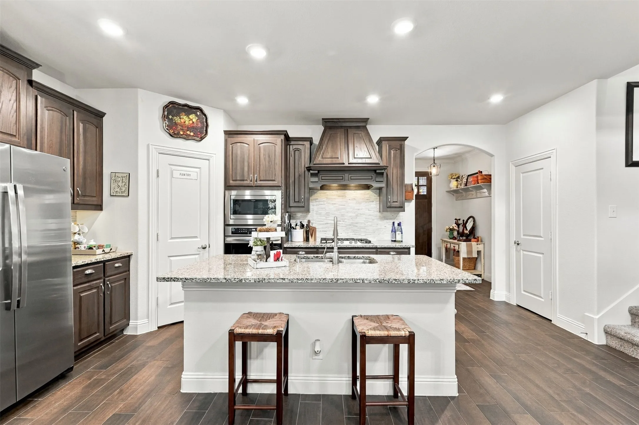 Gas stove, granite countertops and a walk in pantry open to the living and dining area