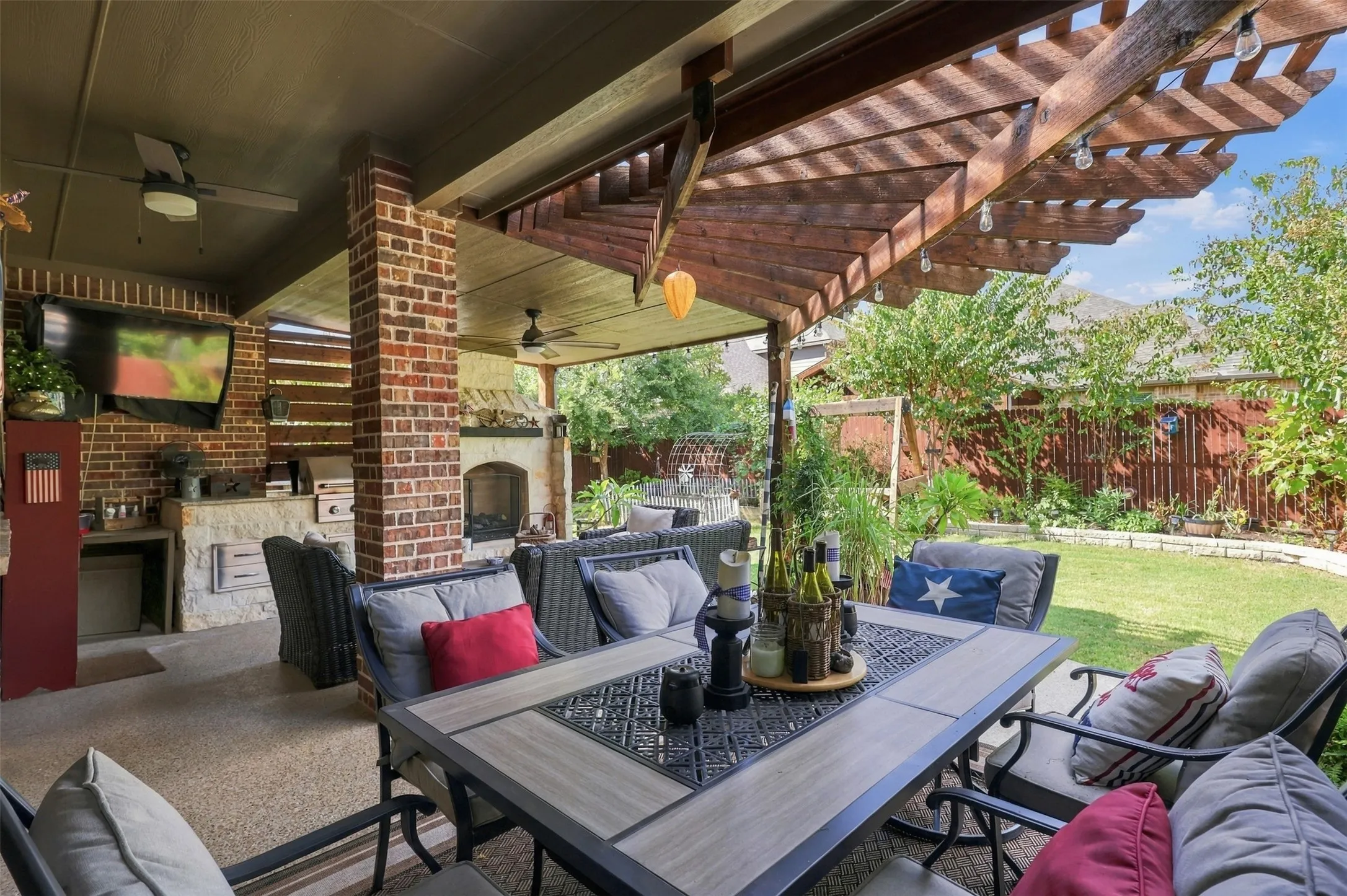This patio is a dream! Extended pergola, built in fire place and grill great for entertaining.