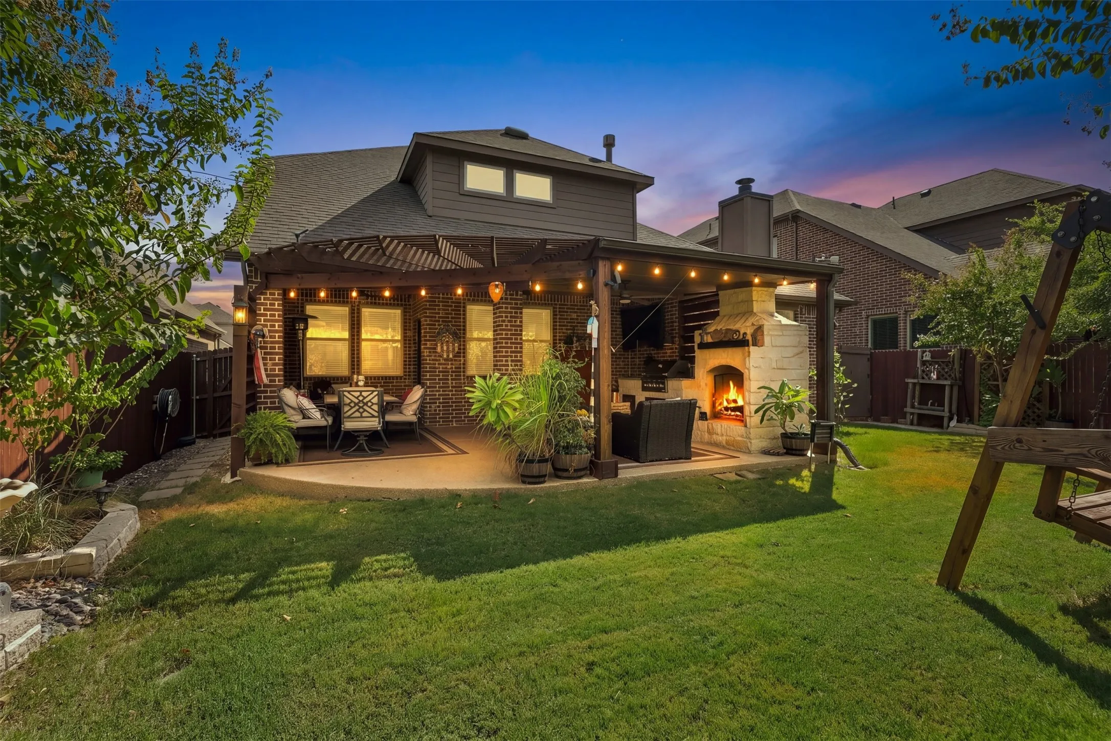 This patio is a dream! Extended pergola, built in fire place and grill great for entertaining.