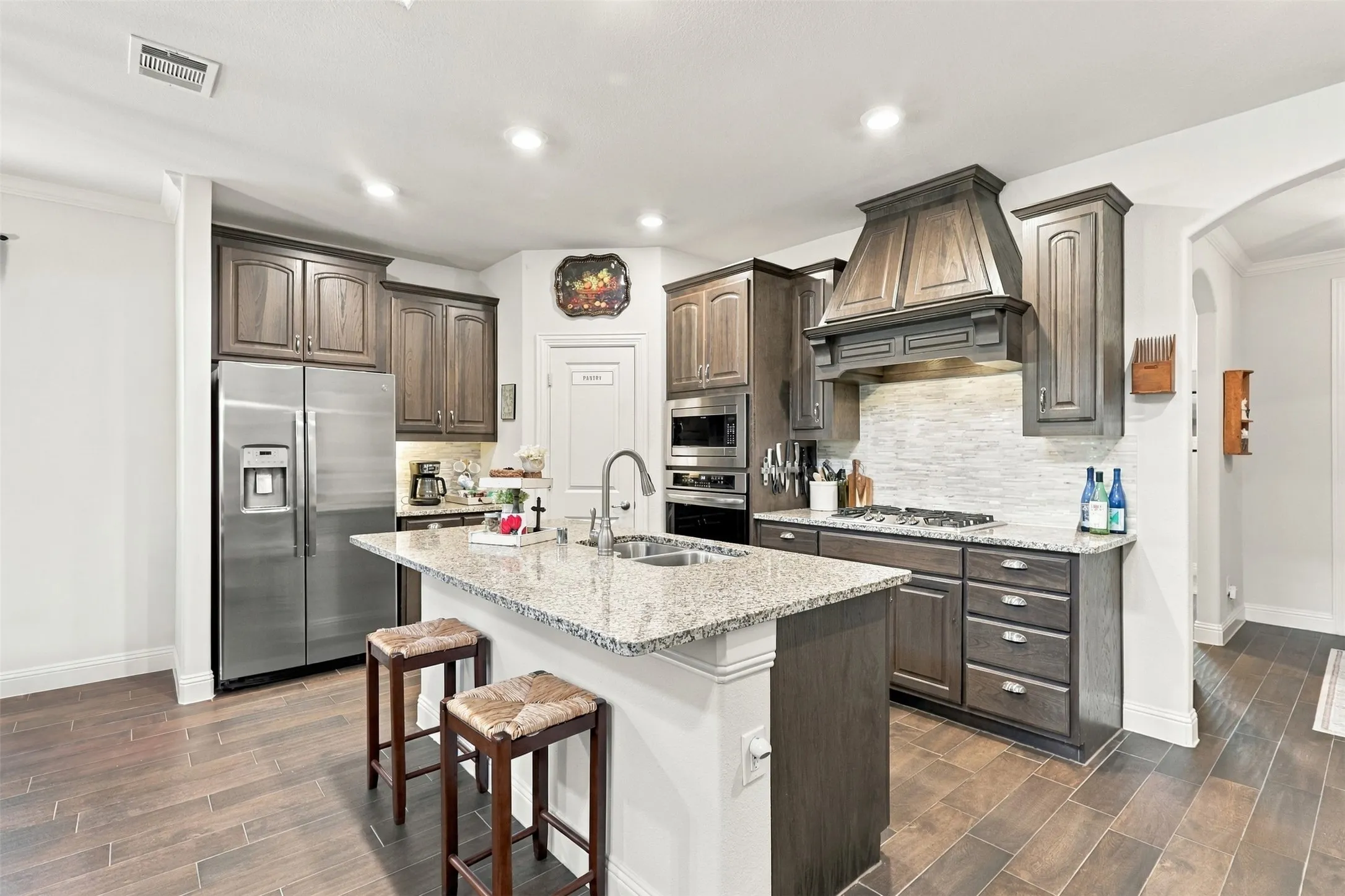 Gas stove, granite countertops and a walk in pantry open to the living and dining area