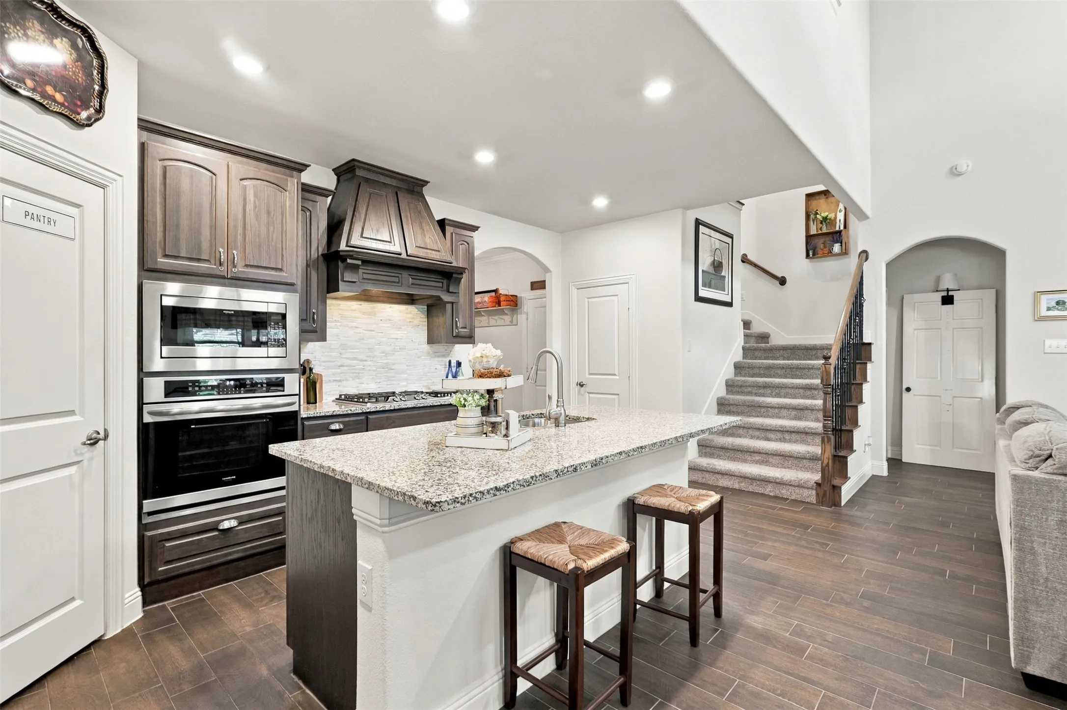 Gas stove, granite countertops and a walk in pantry open to the living and dining area