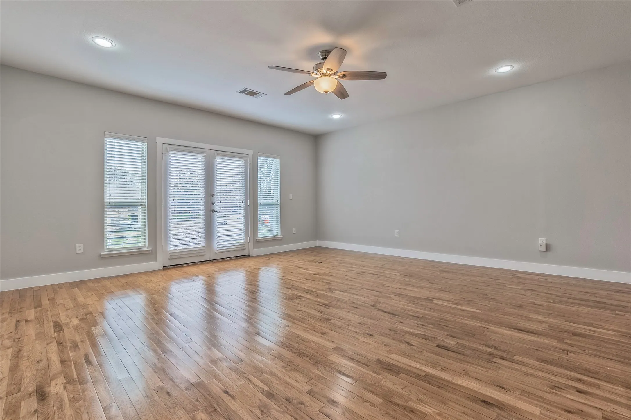 Recessed lighting, ceiling fan, wood-finish flooring, light gray walls, and white trim