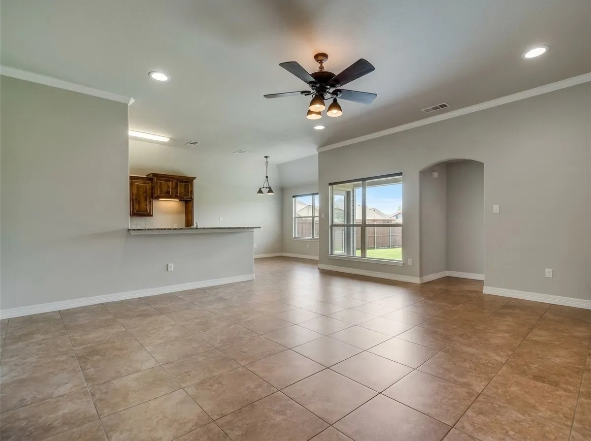 Tile flooring, recessed lighting, crown molding, built-in shelving, and a ceiling fan with integrated lighting