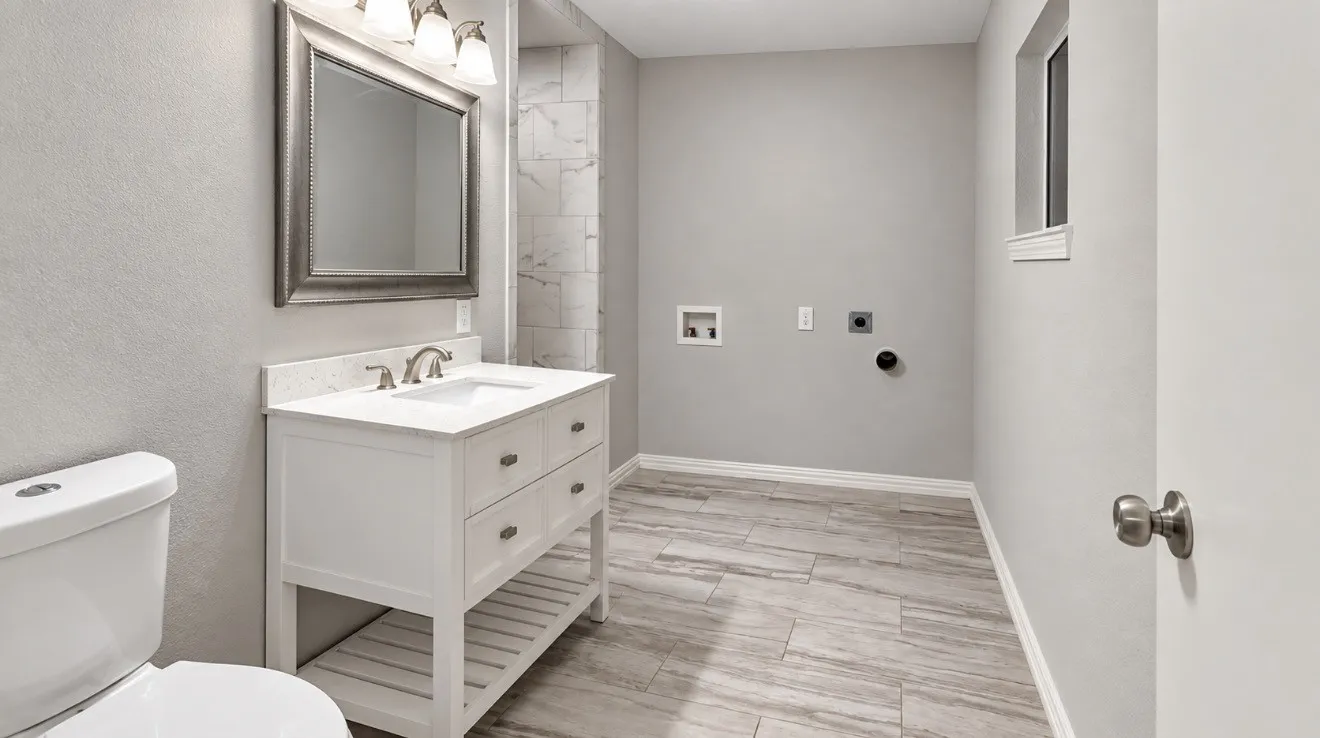 Full bathroom with a white vanity, integrated sink, and brushed nickel hardware