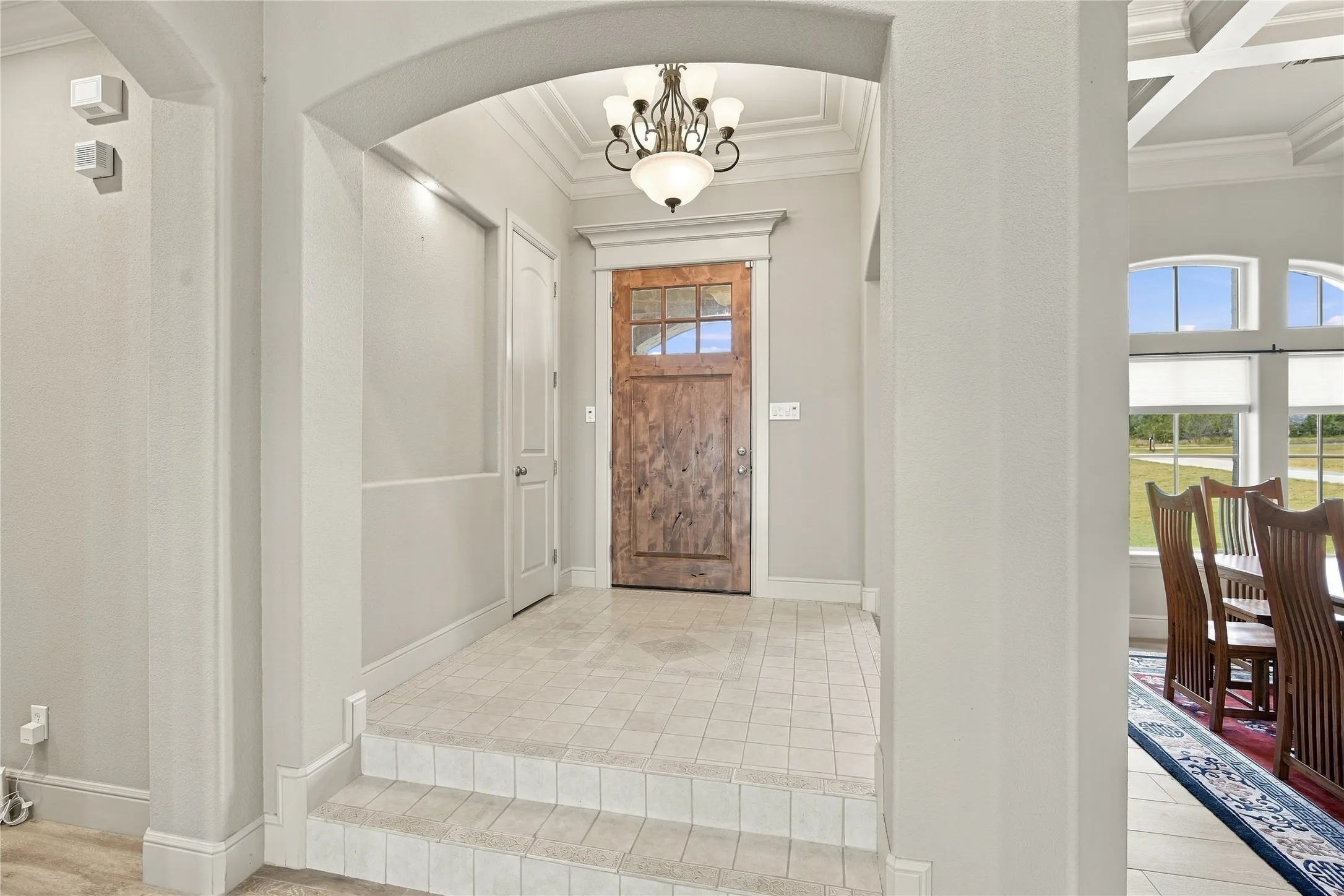 Step through the arched entry onto durable tile flooring, a warm and welcoming first impression.