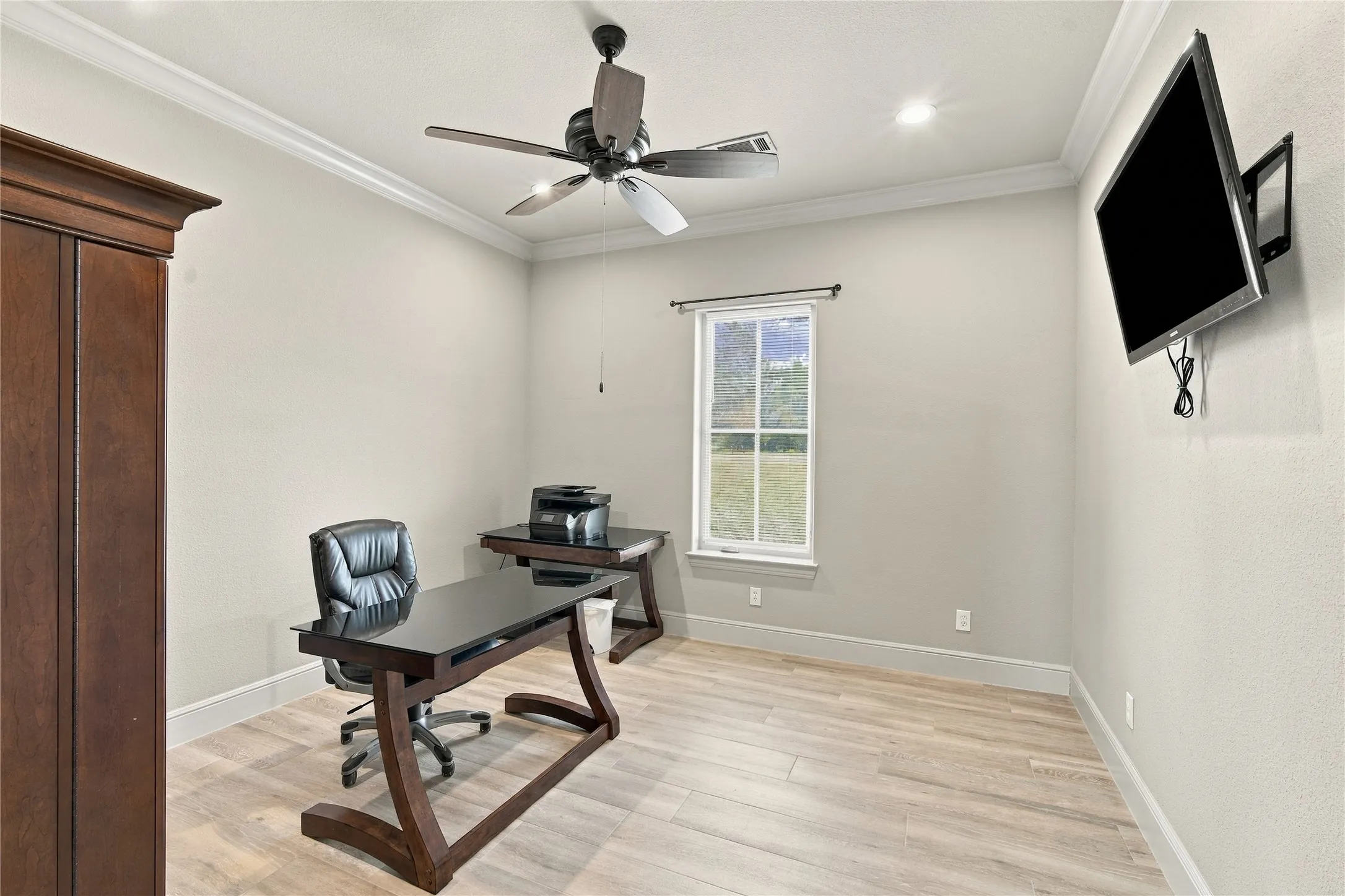 A quiet home office with crown molding and great natural light, ready for remote work or a private study.