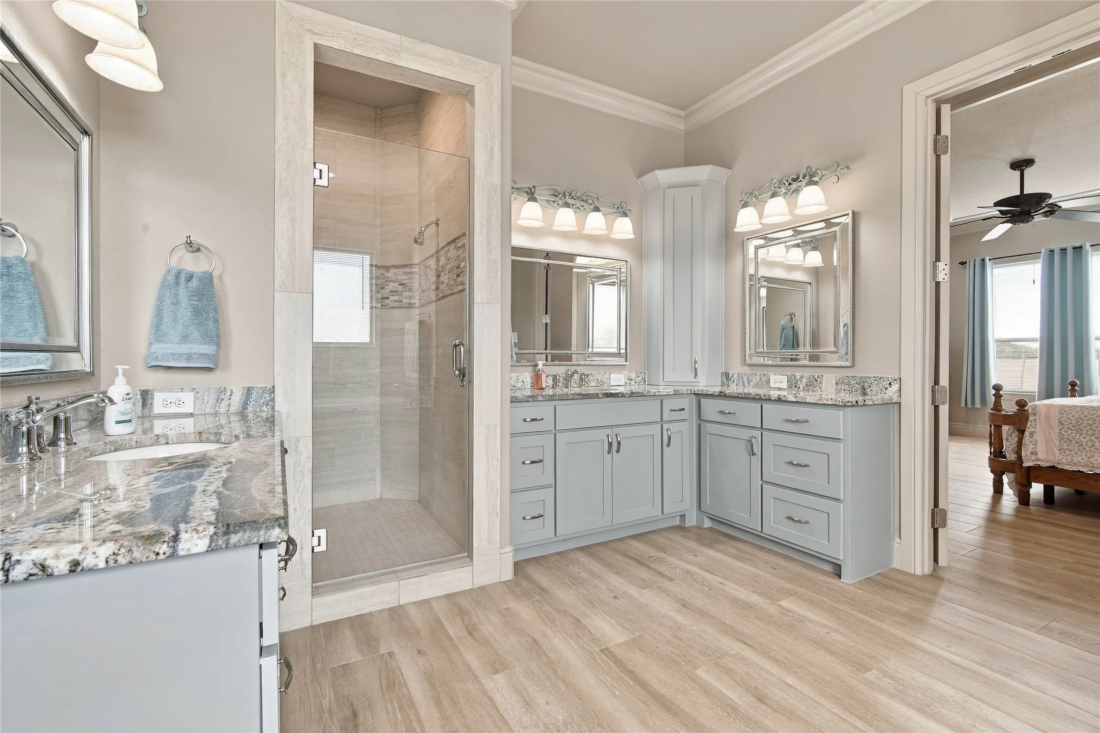 A glass-enclosed shower and dual vanities add everyday luxury to the primary bathroom.