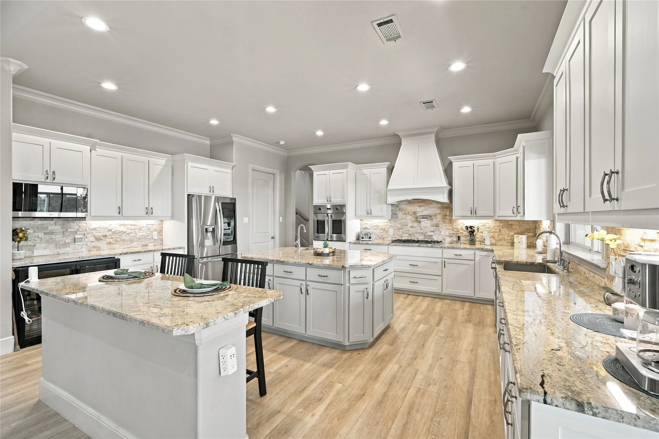 Two oversized islands make this kitchen a natural gathering spot, ideal for meal prep, casual dining, or entertaining a crowd.
