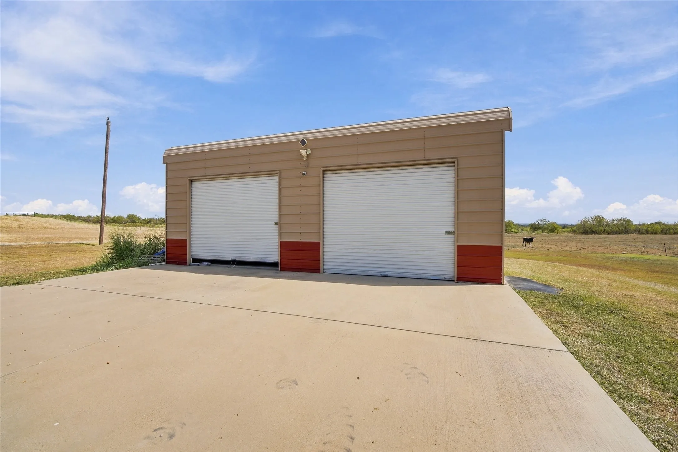 A detached two-bay garage/barn offers extra space for vehicles, equipment, or a workshop.
