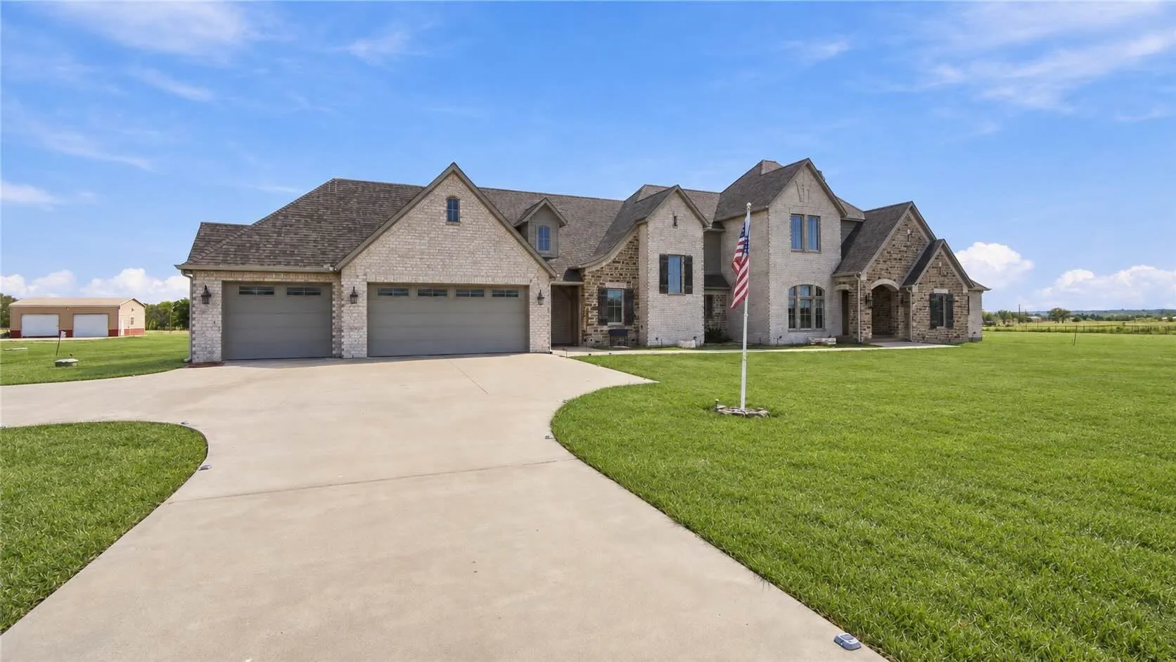 An expansive driveway and front lawn lead up to this stone-and-brick beauty, giving guests plenty of room to park and gather.