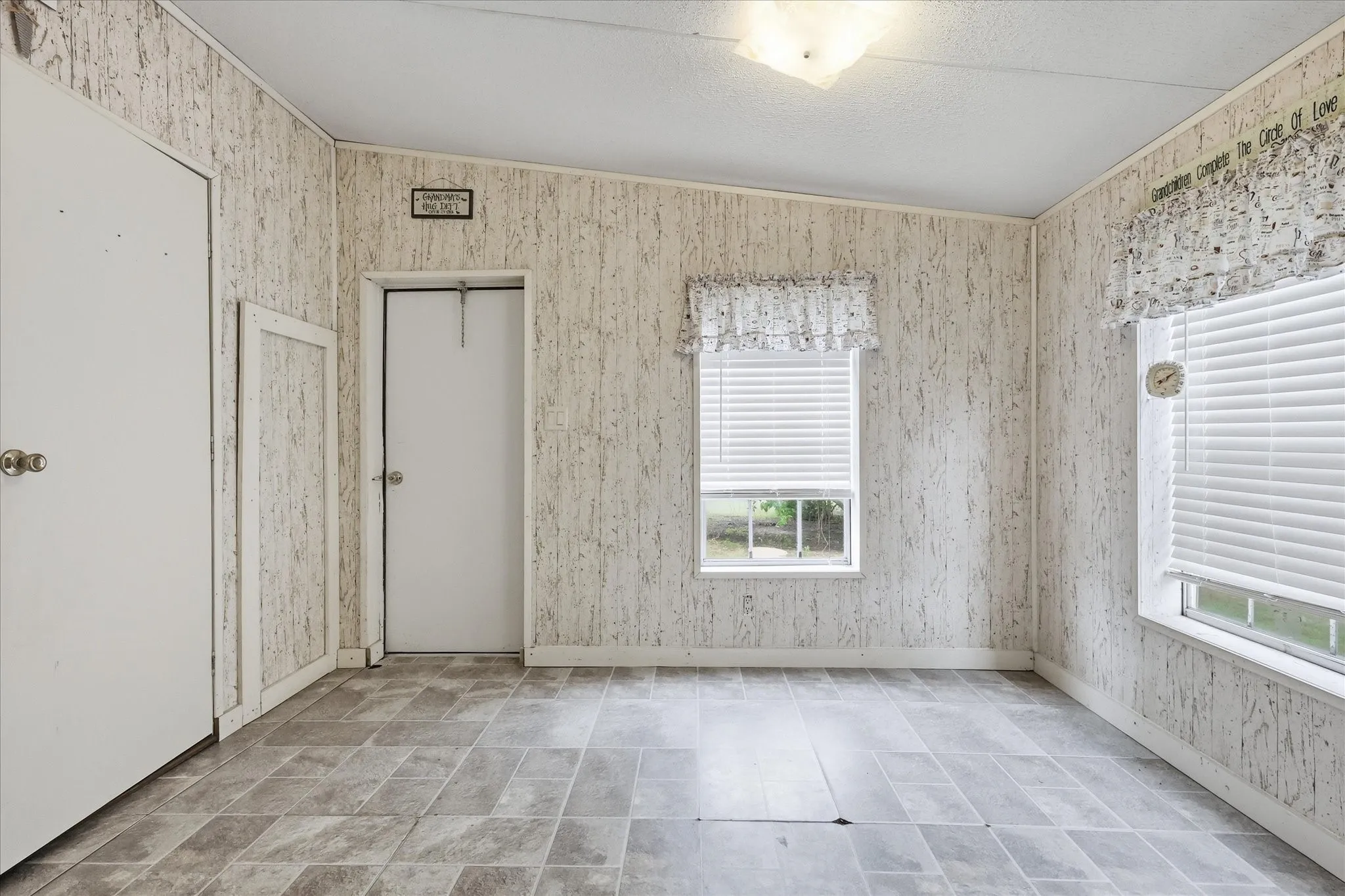 Patterned wall paneling complemented by gray tile flooring