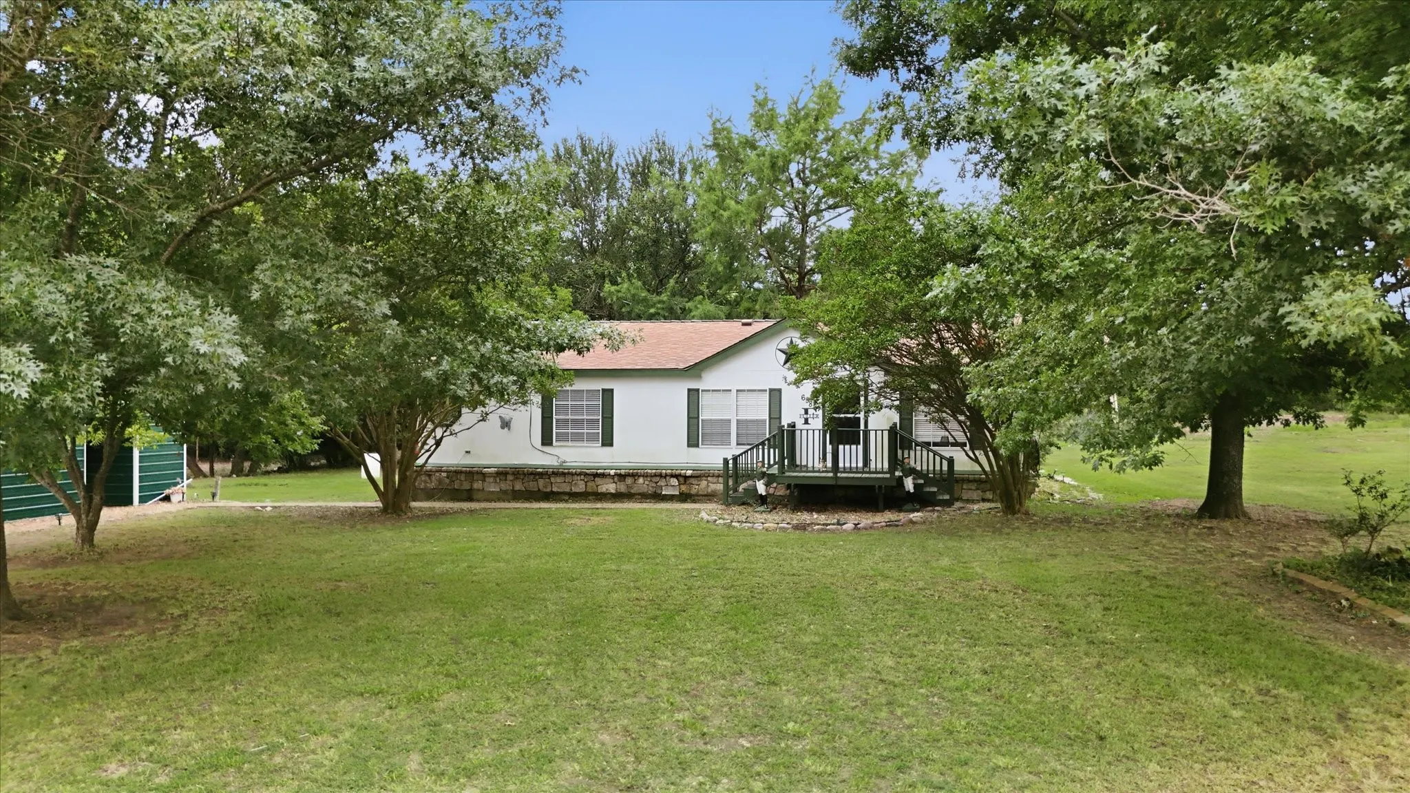 Expansive green lawn with mature trees
