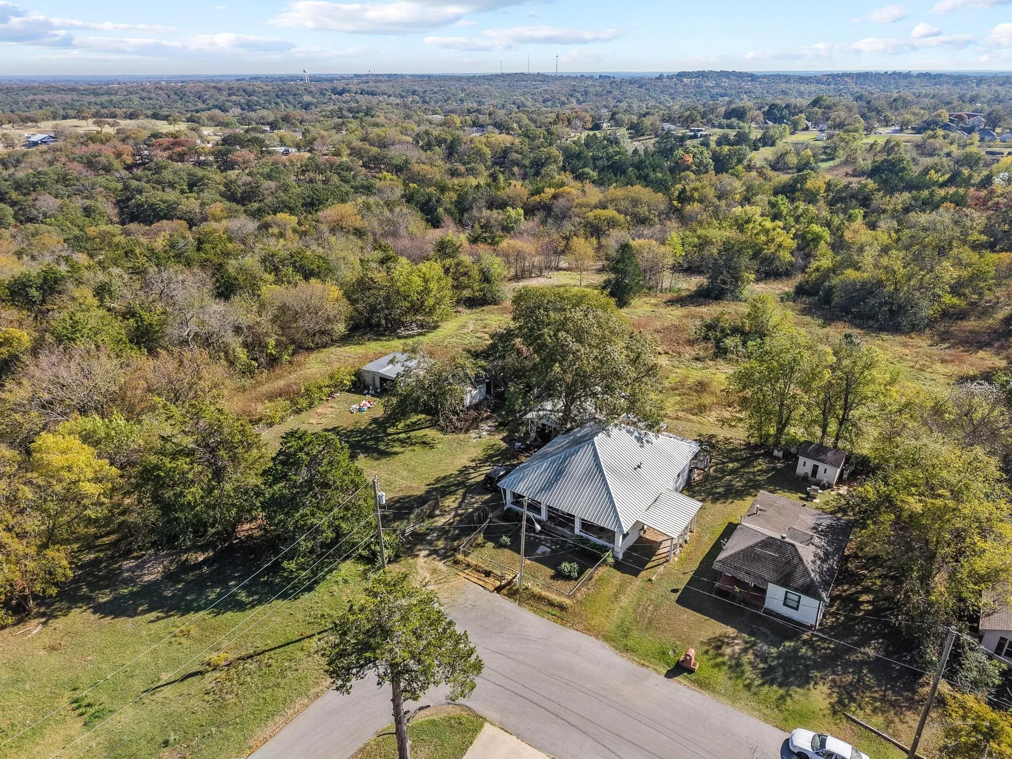 Expansive lot featuring mature trees and a wooded backdrop