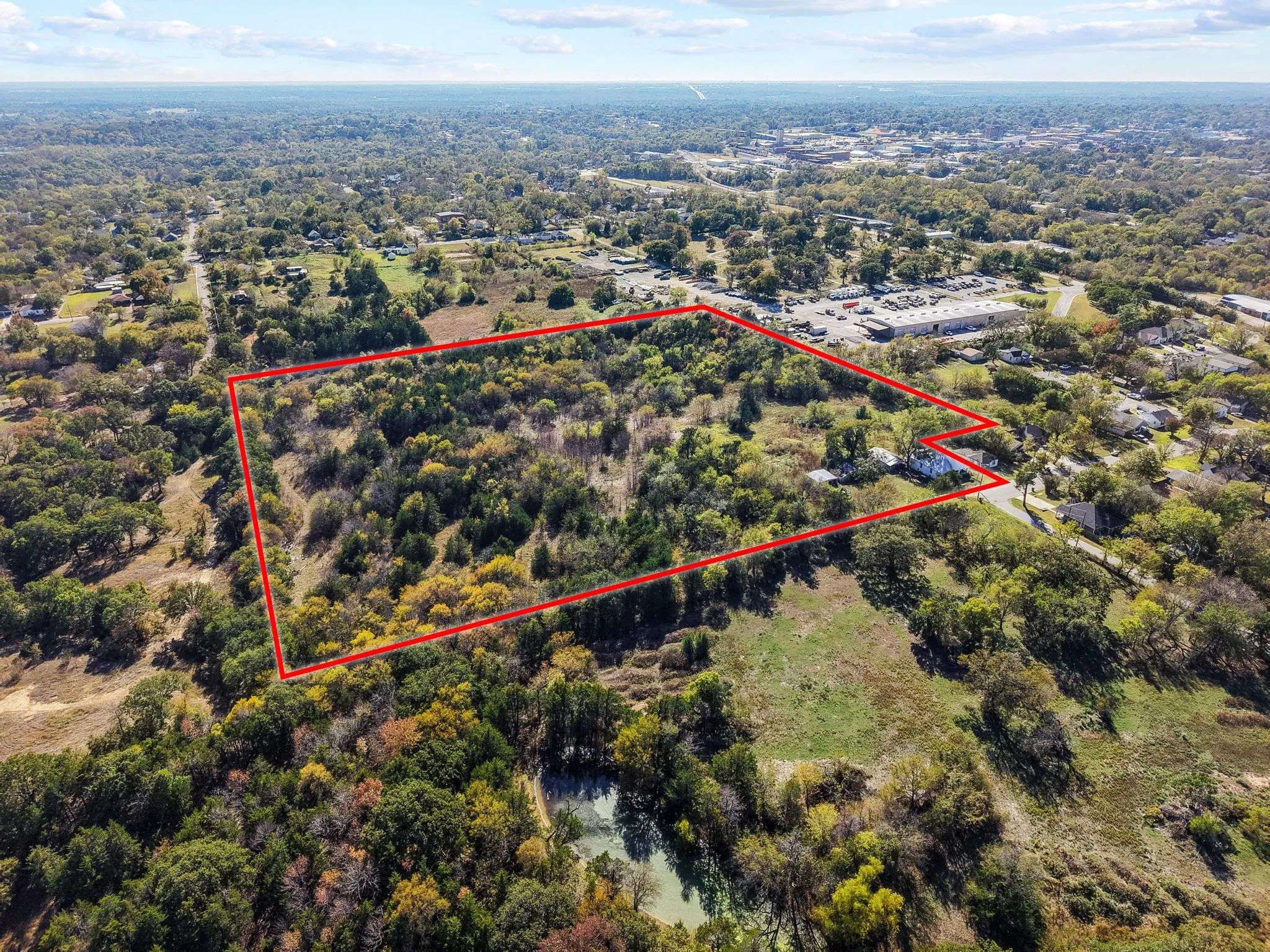 Expansive undeveloped land featuring a mix of mature trees and open clearings