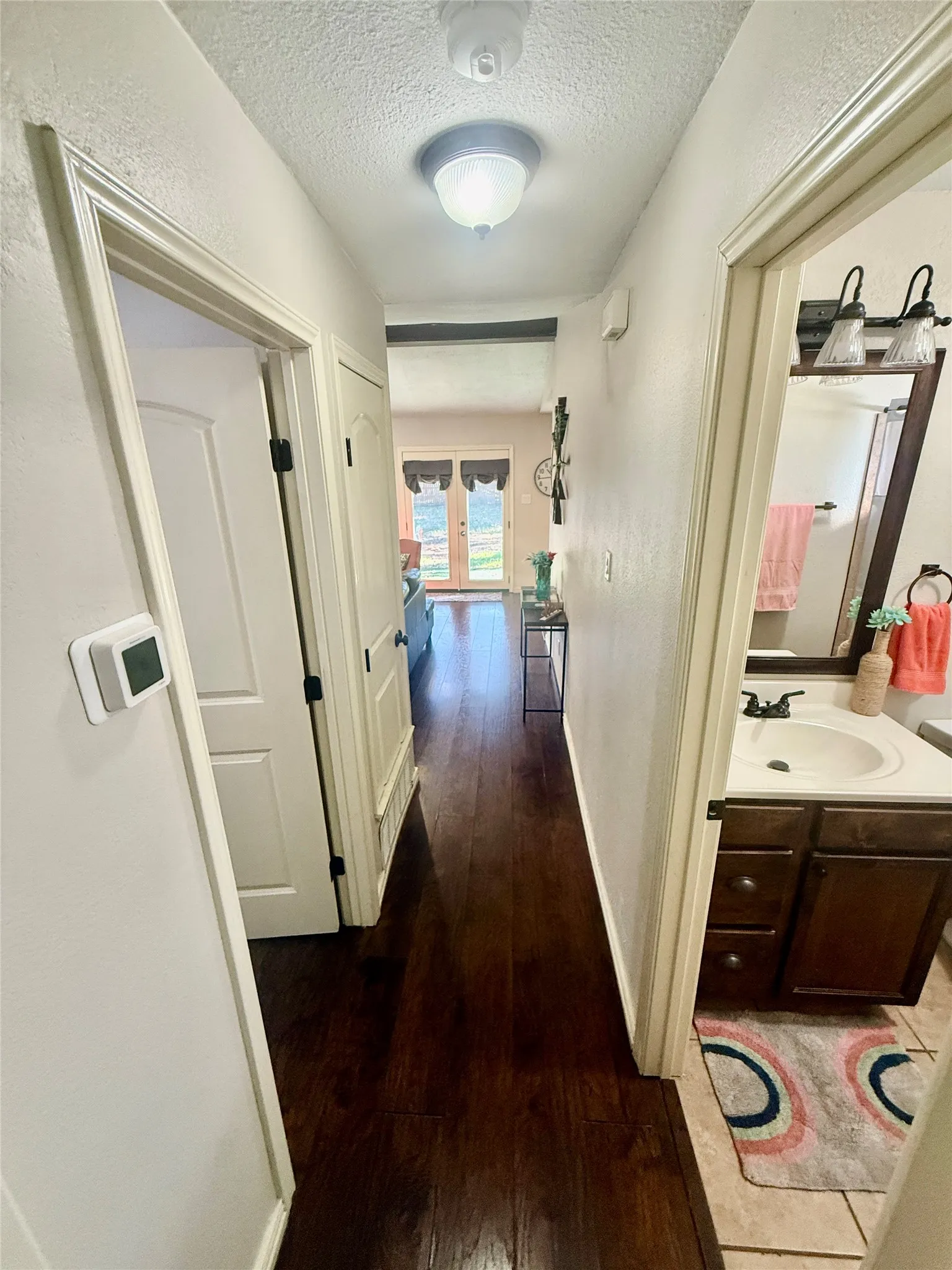 Dark wood-finish flooring extending through a hallway